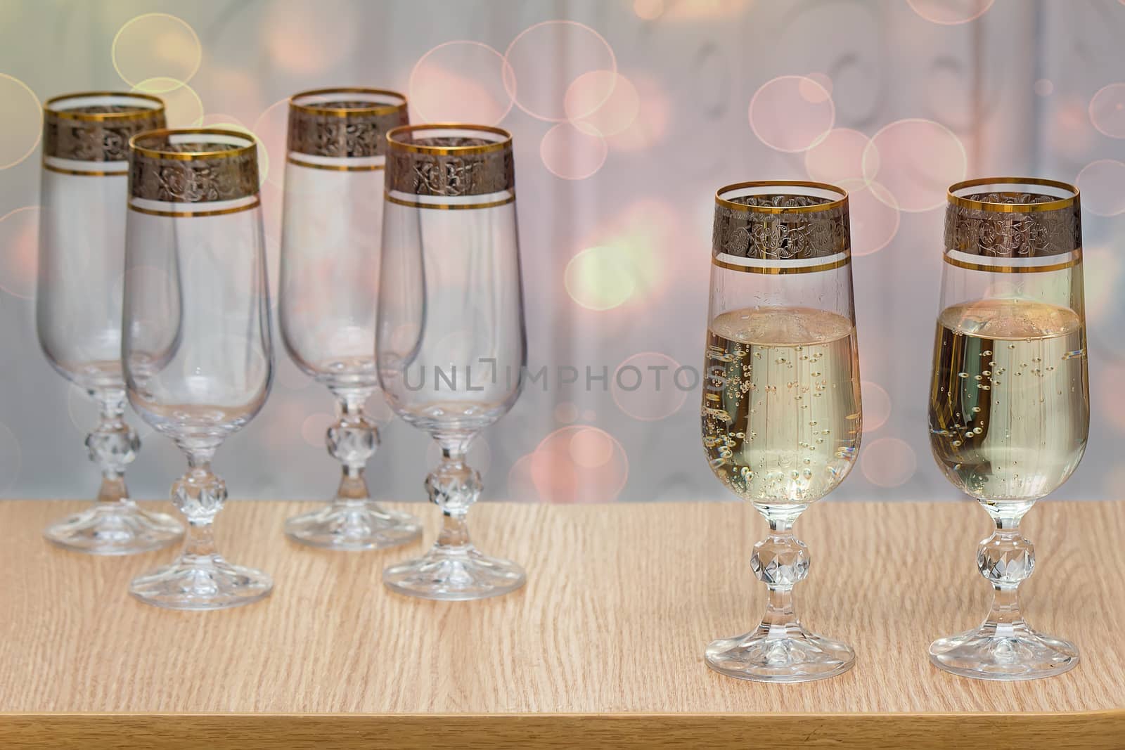 Six beautiful glass wine glasses, two filled with champagne. by georgina198
