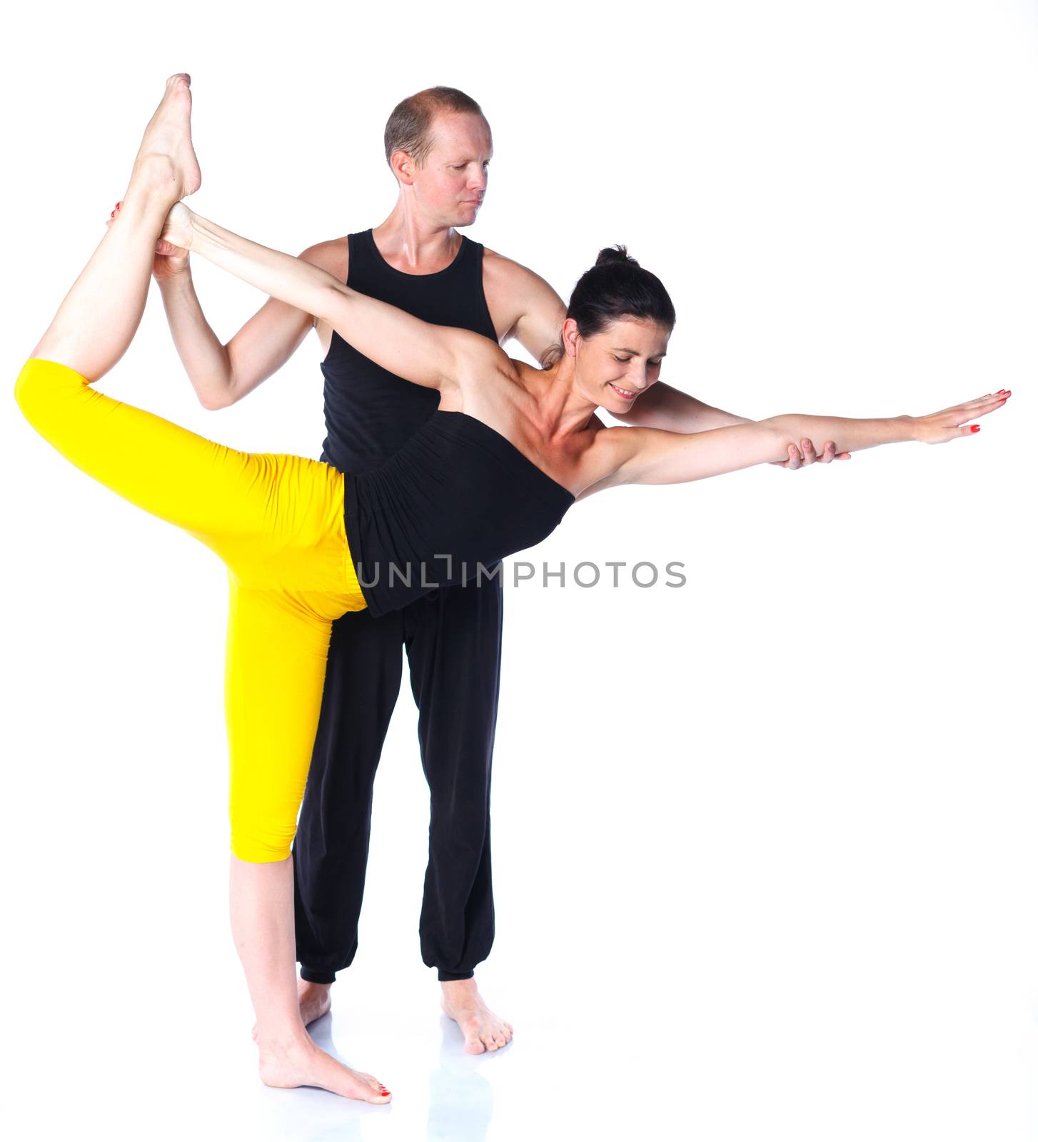 Young couple doing yoga. Isolated on white backgraund