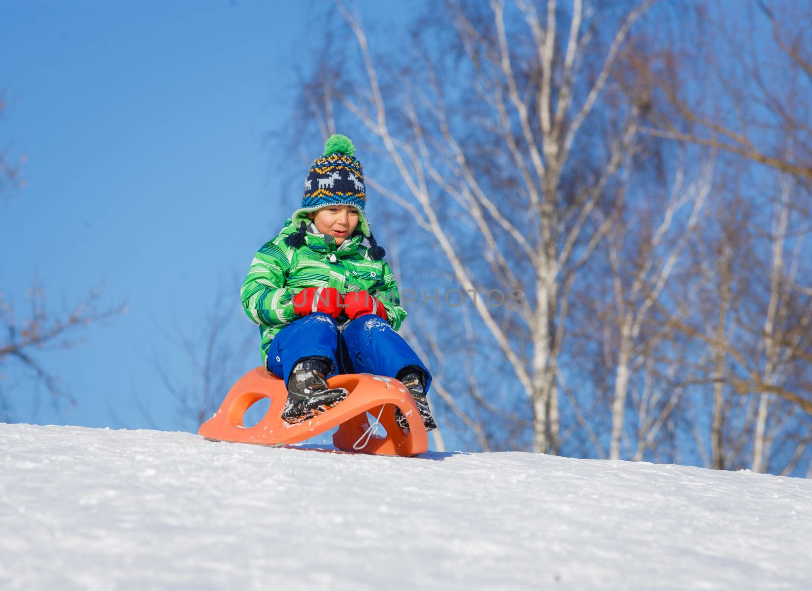 Winter, play, fun - Cute little boy having fun with sled in winter park