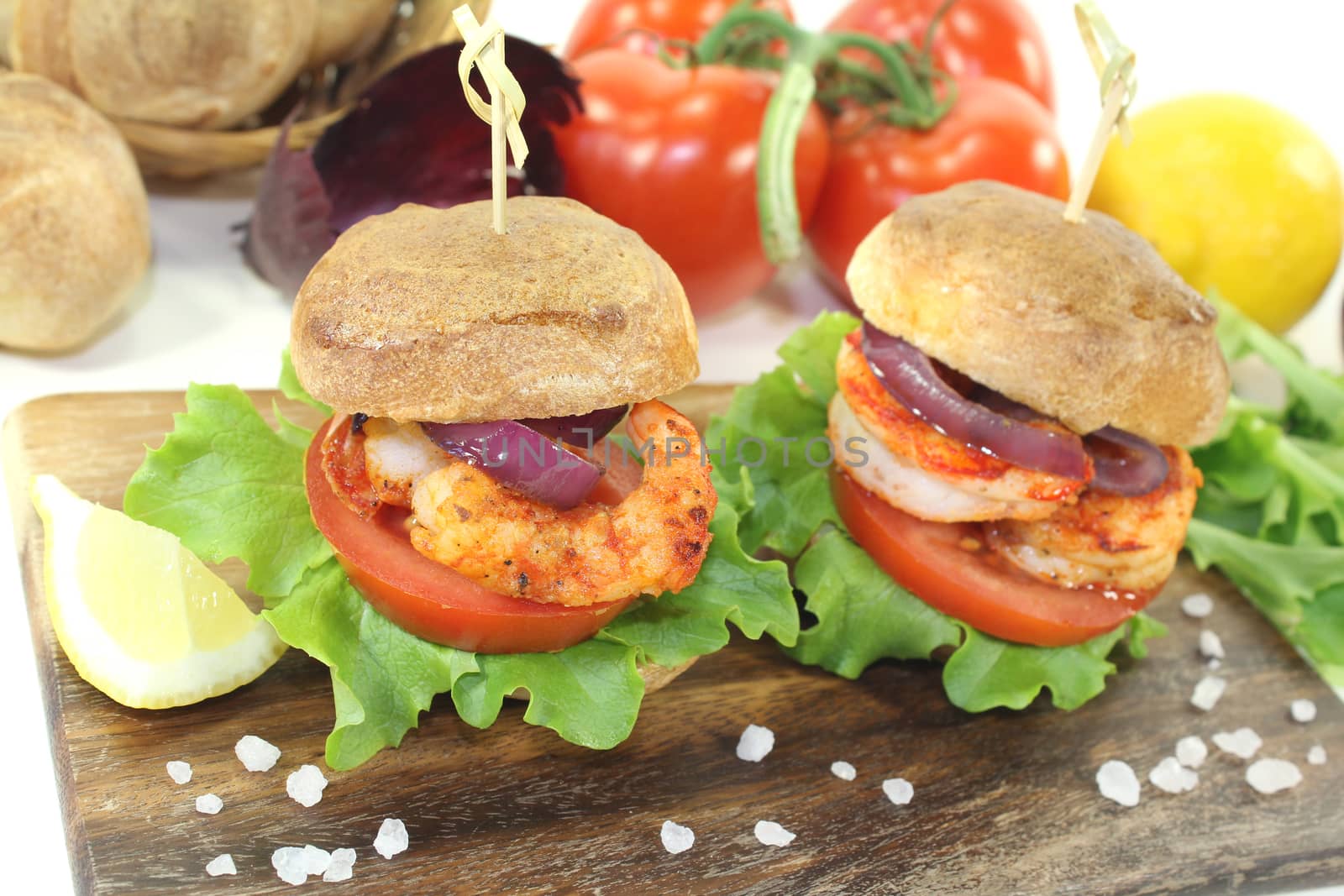 healthy delicious shrimp burgers with tomatoes, red onion and lettuce