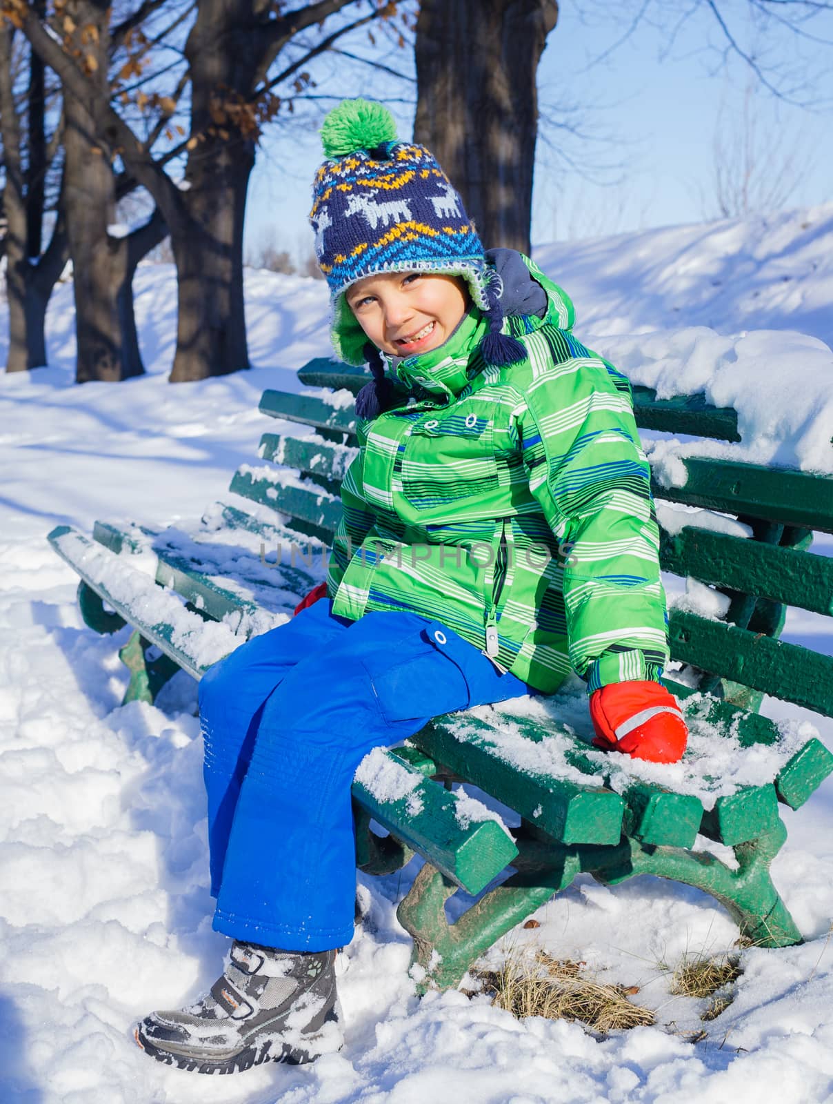 Little boy in winter park by maxoliki