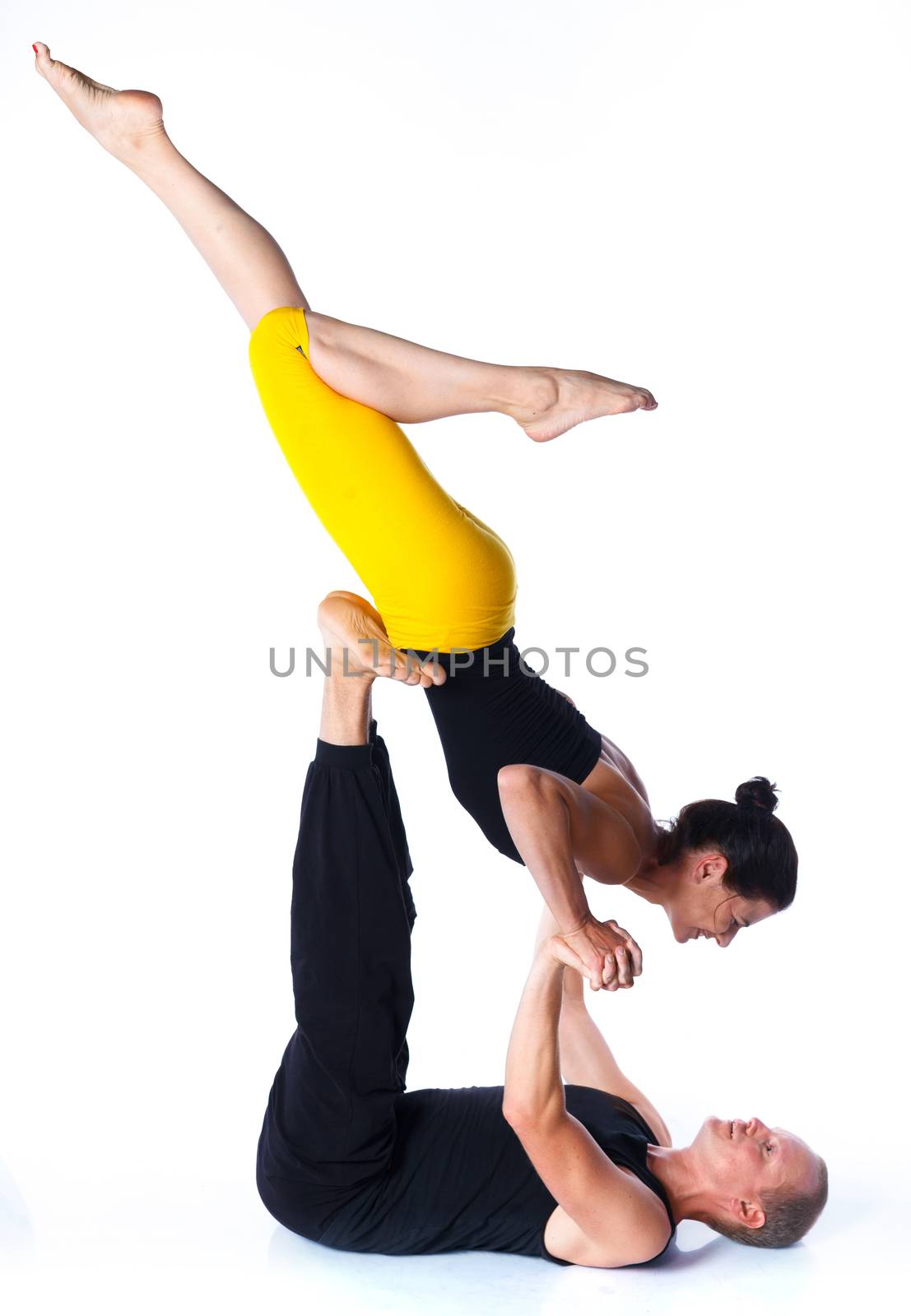 Young couple doing yoga. Isolated on white backgraund