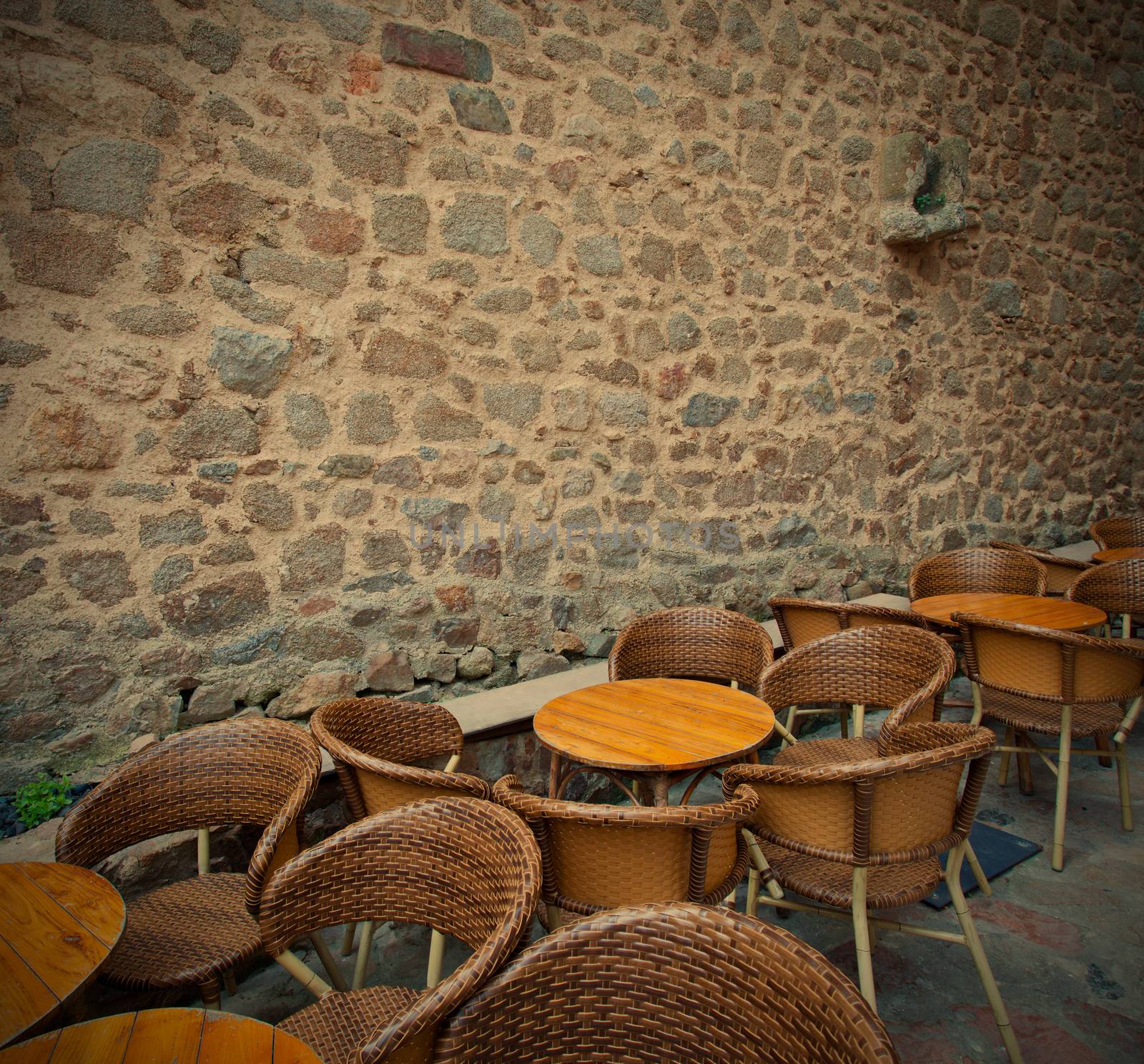 summer cafe near the ancient stone wall by Astroid