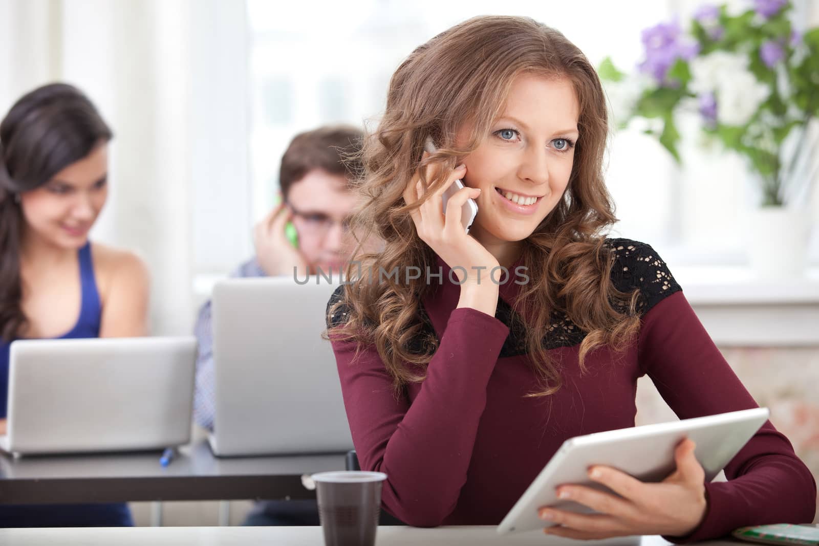 smiling student with smartphone talking 