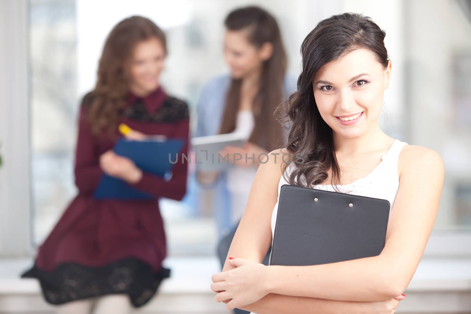 Portrait of smiling pretty girl looking at camera in college