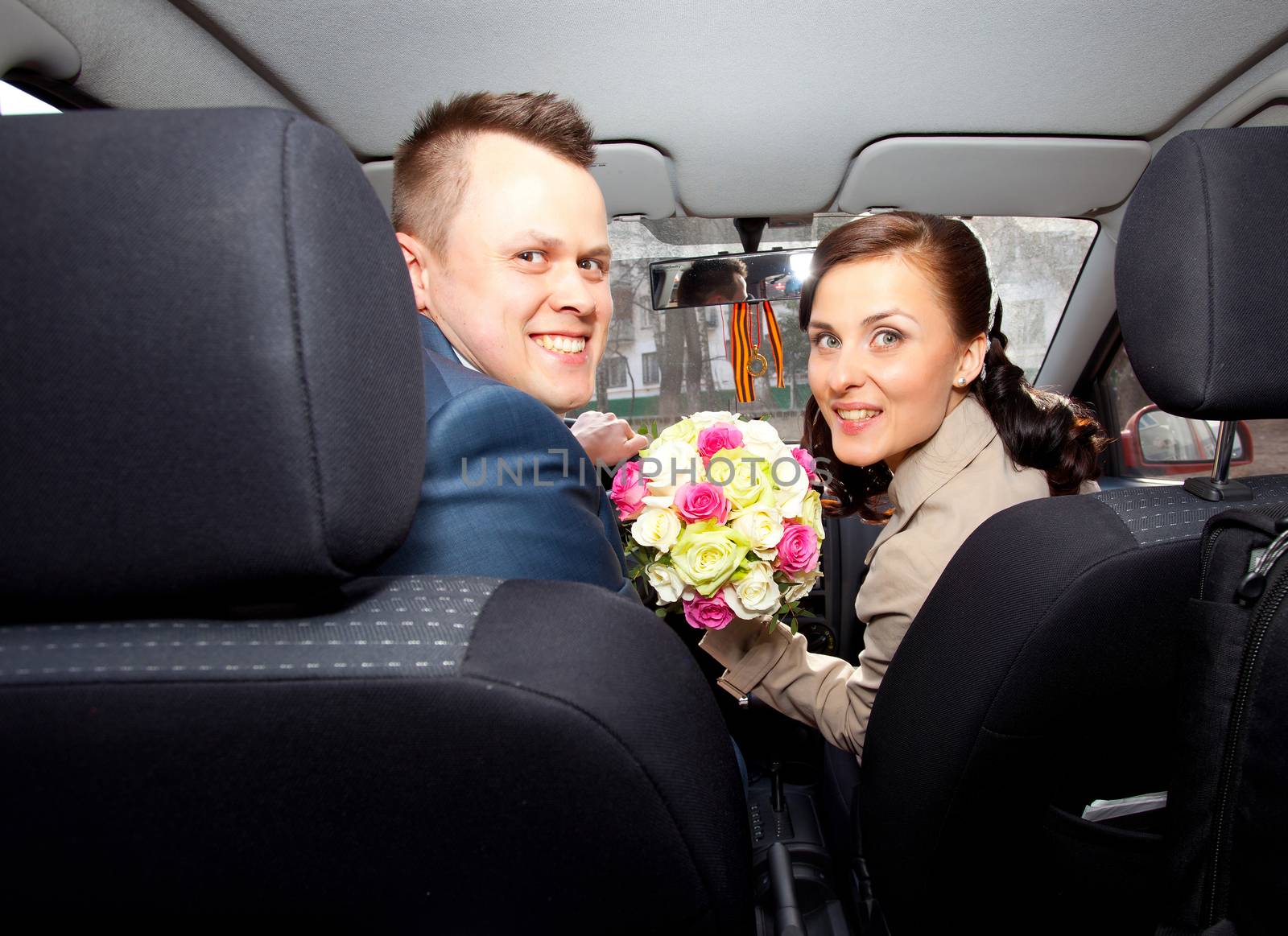beautiful bride and groom in wedding car