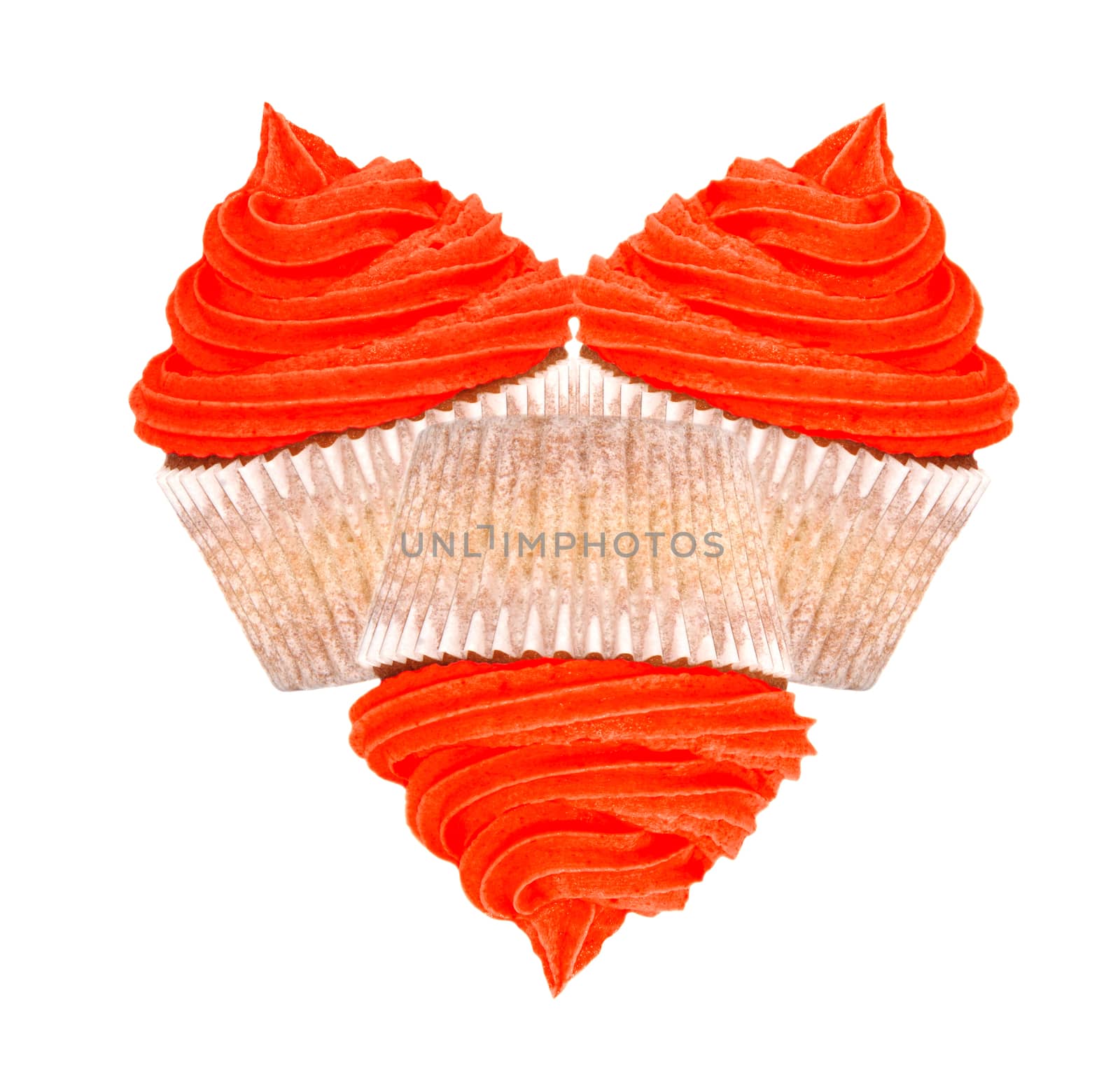 Heart-shaped arrangement of three cupcakes with red frosting for Valentines Day, isolated on a white background