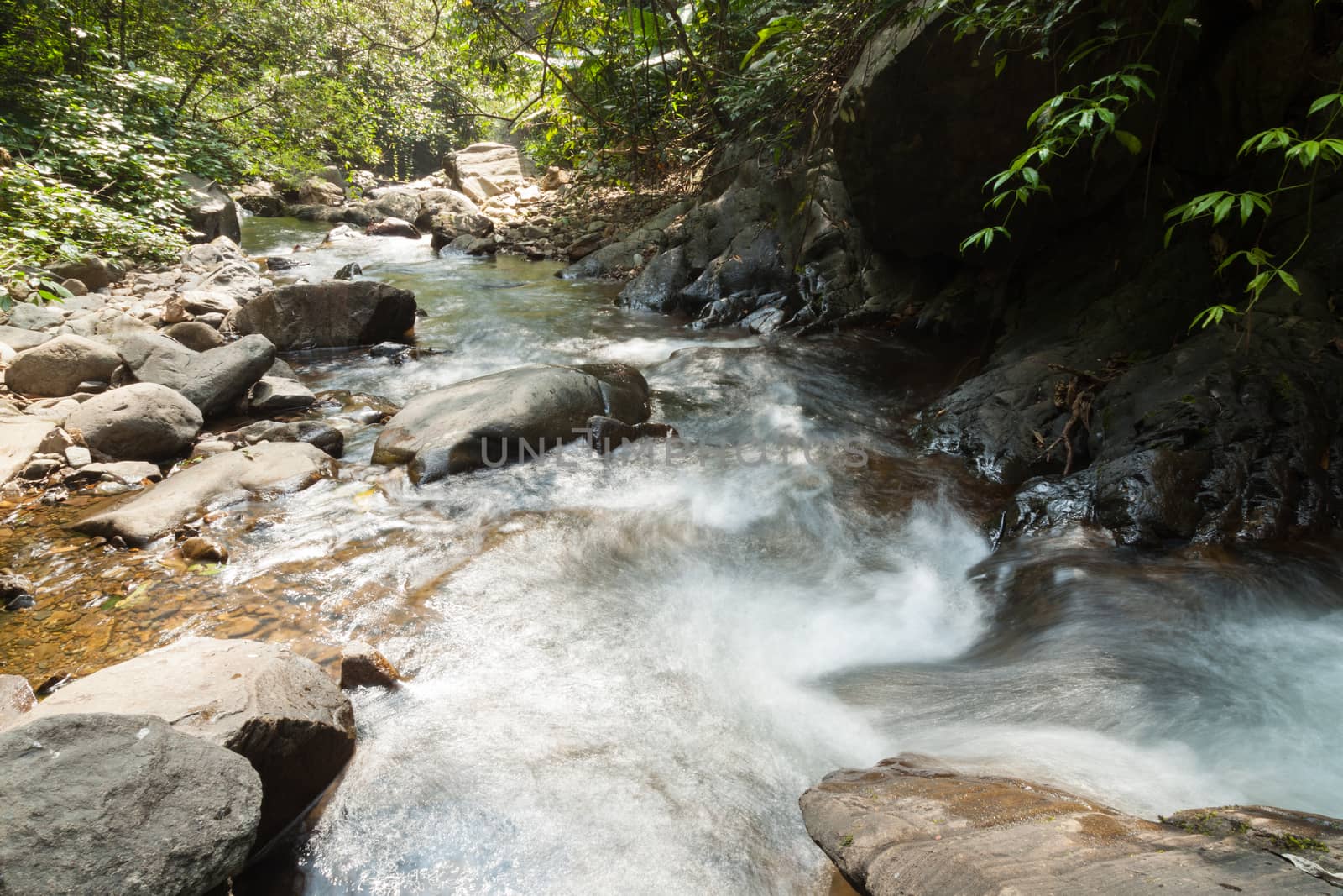 Waterfall that flows down from the mountains. Streams of water flowing down from the mountains. There is always a small stone waterfall.