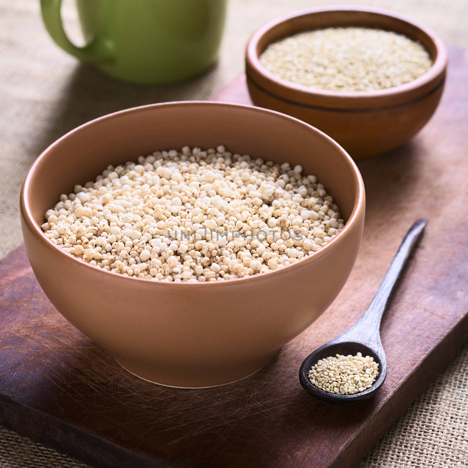 Popped white quinoa (lat. Chenopodium quinoa) cereal in bowl photographed with natural light (Selective Focus, Focus one third into the quinoa cereal)