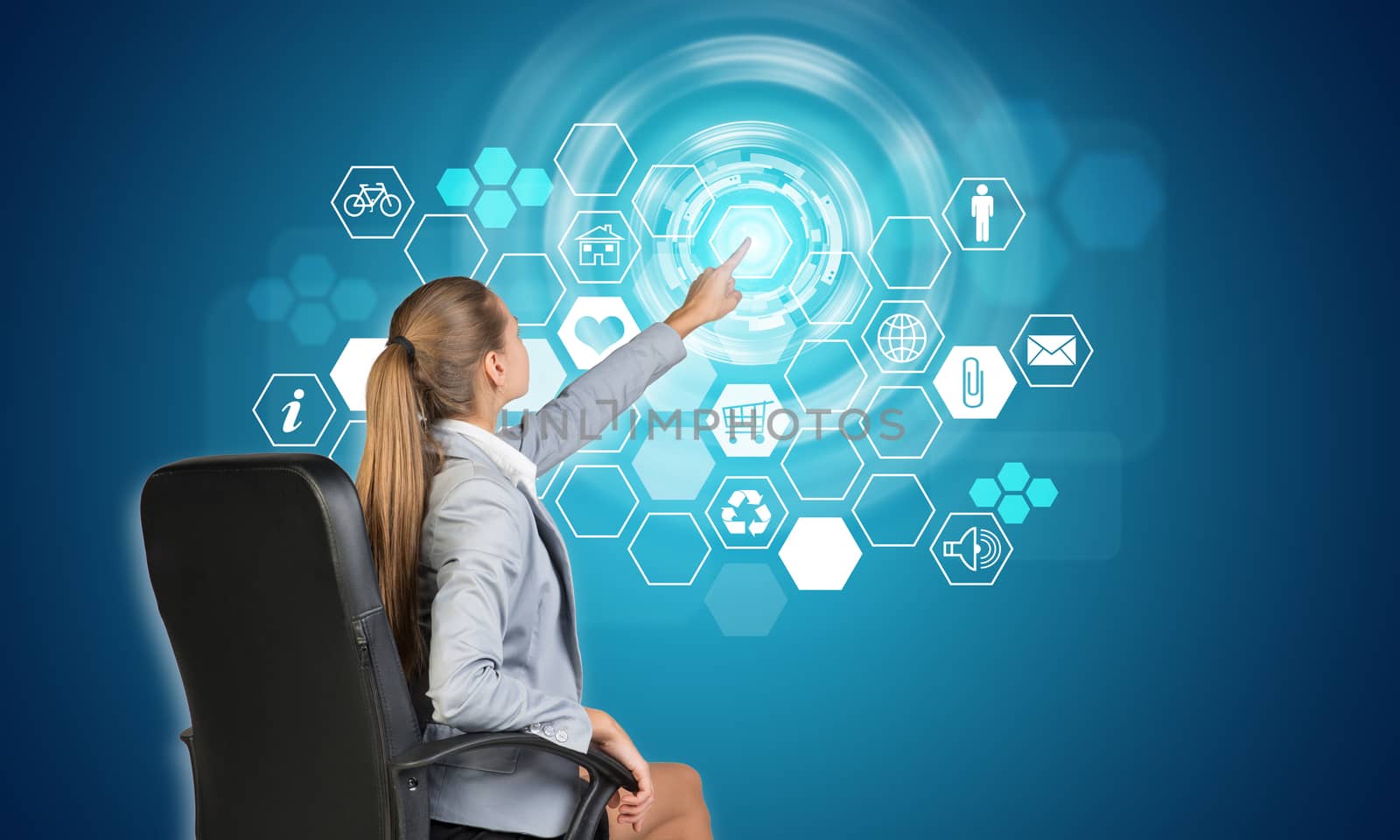 Businesswoman pressing touch screen button on virtual interface with honeycomb shaped icons, on blue background