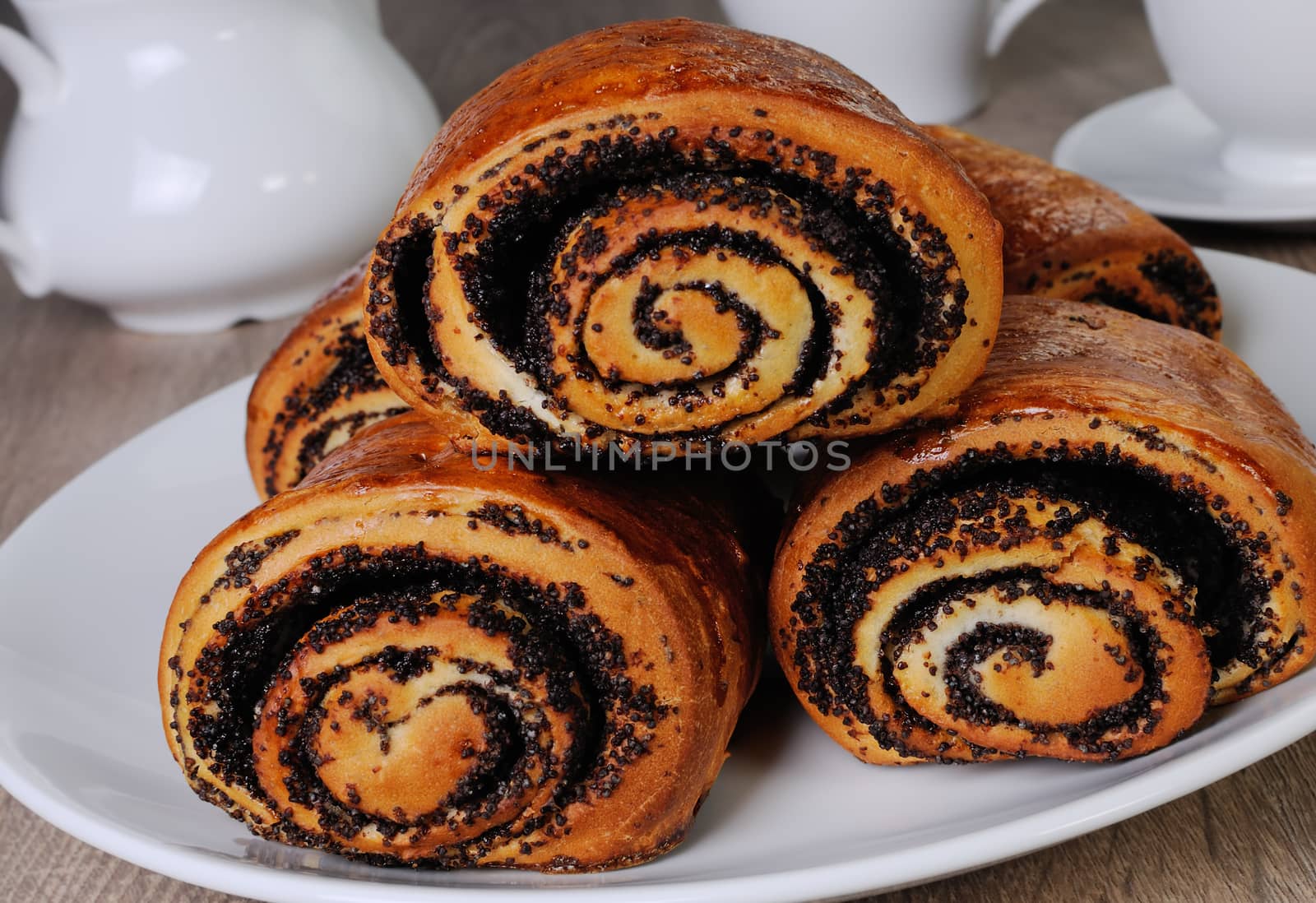 Freshly baked rolls with poppy seeds on a plate