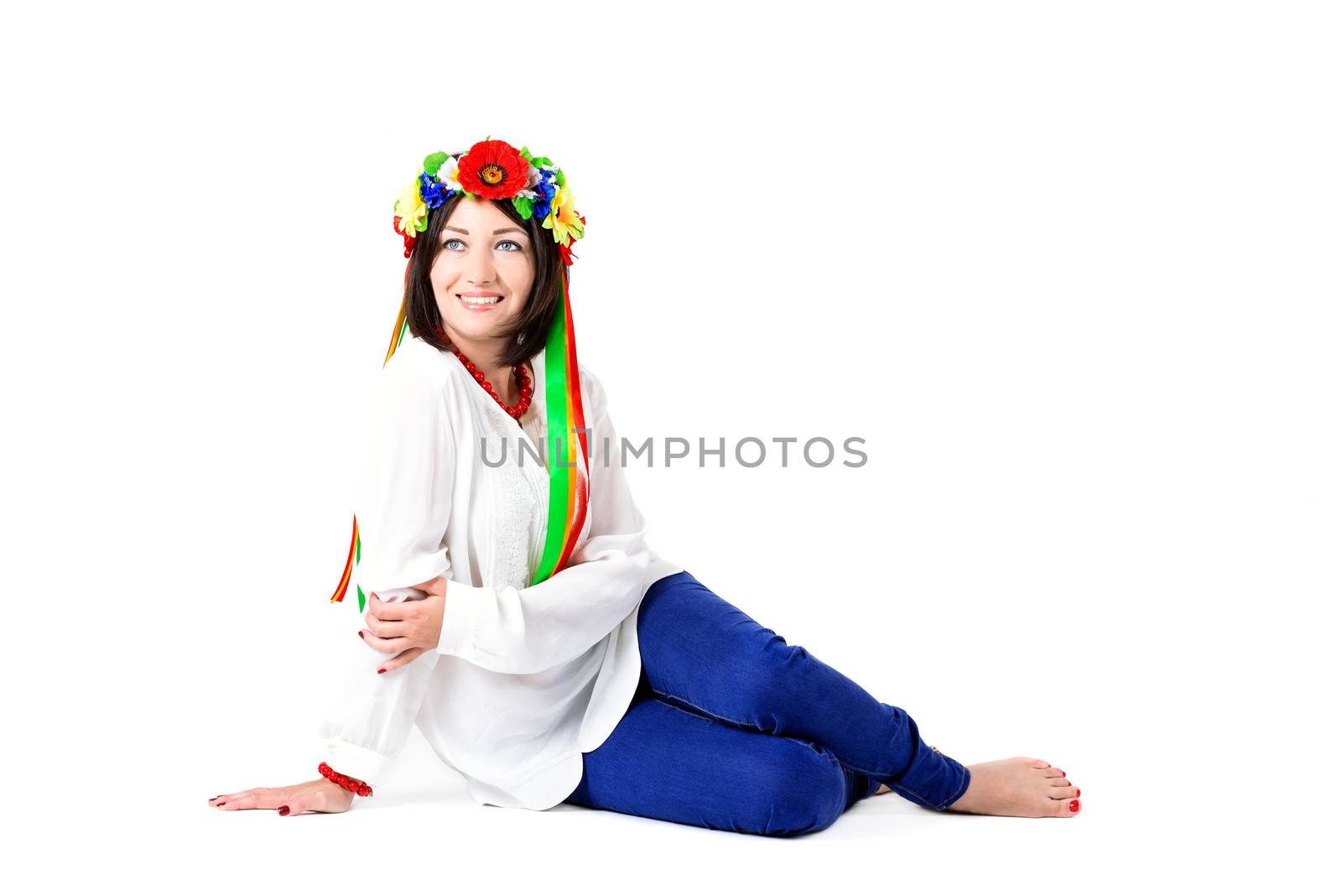 beautiful young brunette woman wearing national ukrainian clothes posing in studio on white background