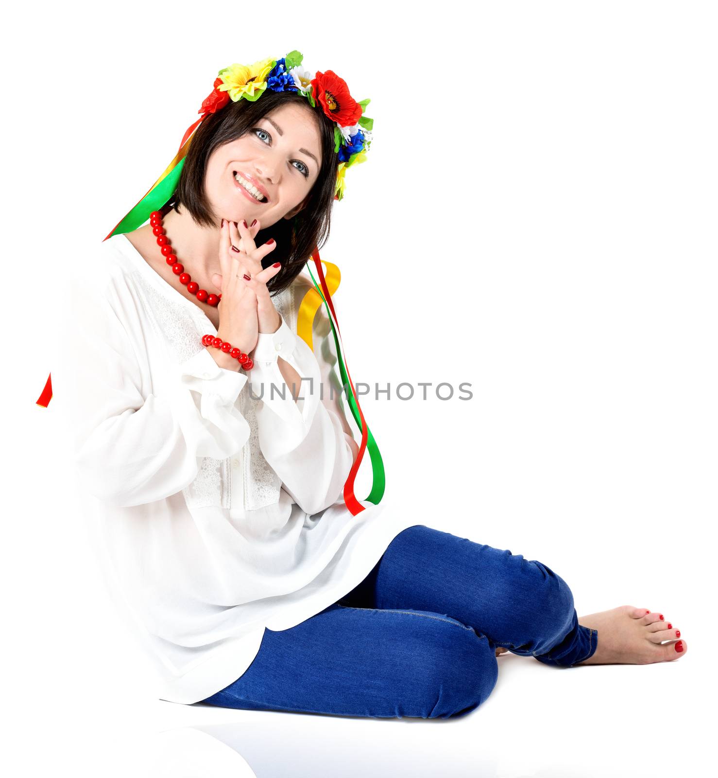 beautiful young brunette woman wearing national ukrainian clothes posing in studio on white background