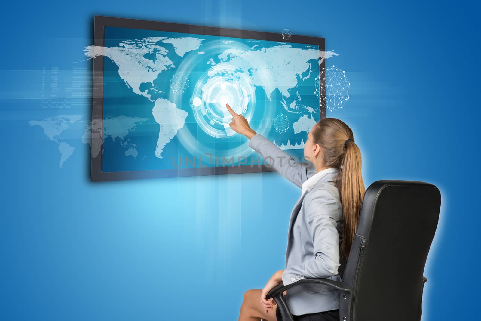 Businesswoman operating touch screen interface with world map, on blue background