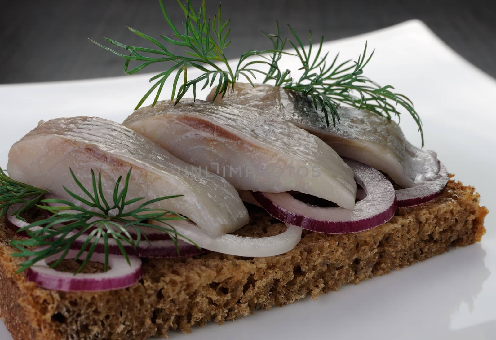 Sliced herring on rye bread with onions
