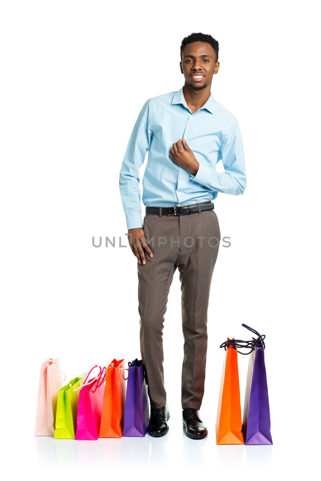 Happy african american man with shopping bags on white background. Holidays concept