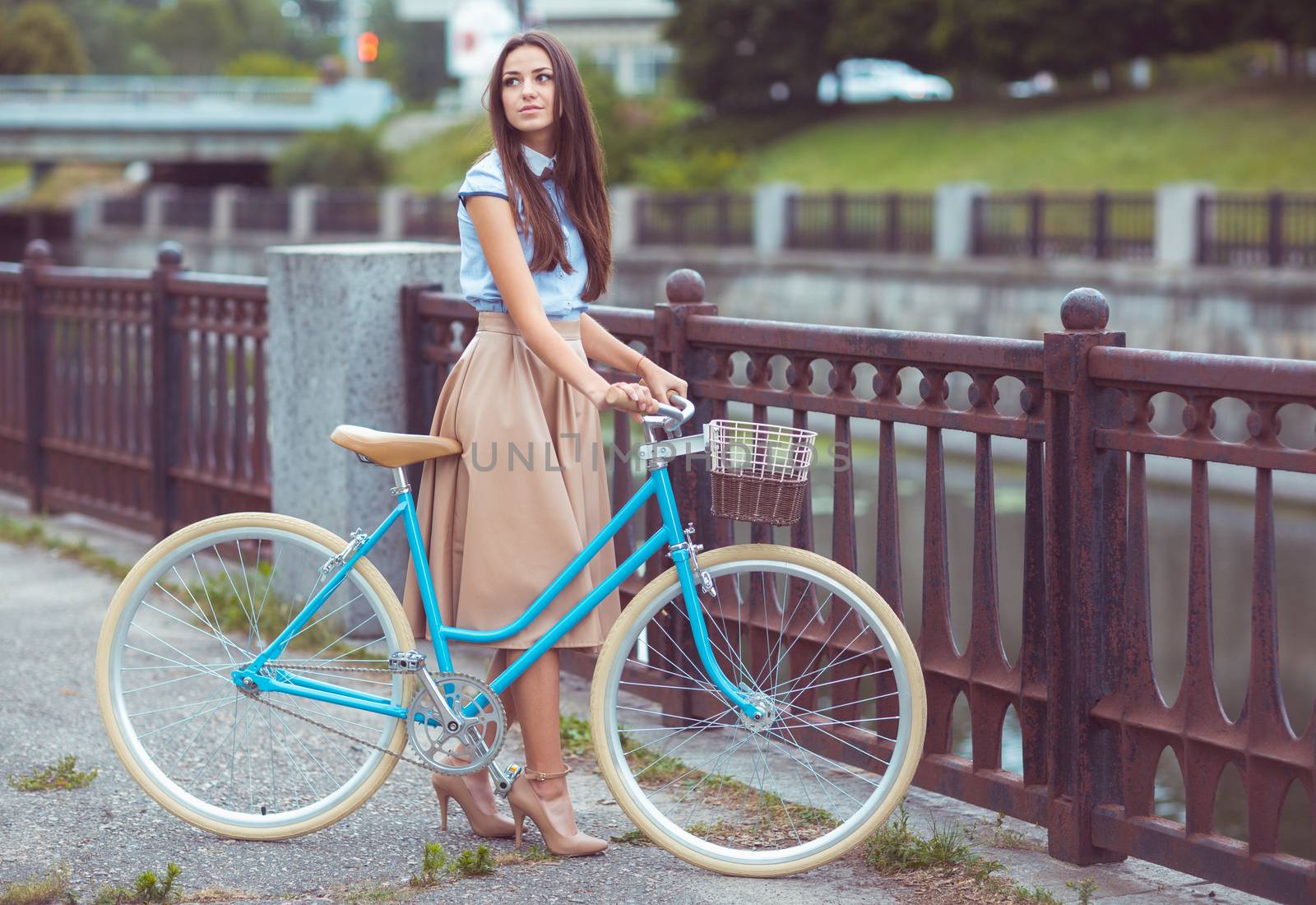 Young beautiful, elegantly dressed woman with bicycle. Beauty, fashion and lifestyle