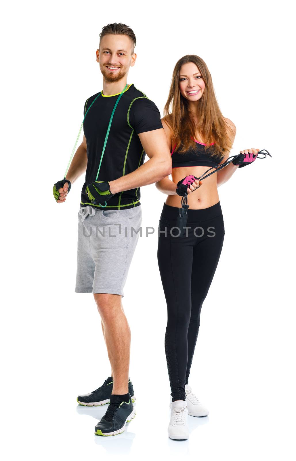 Happy sport couple - man and woman with with ropes on the white background