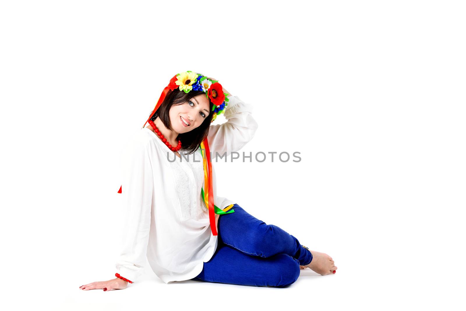 beautiful young brunette woman wearing national ukrainian clothes posing in studio on white background