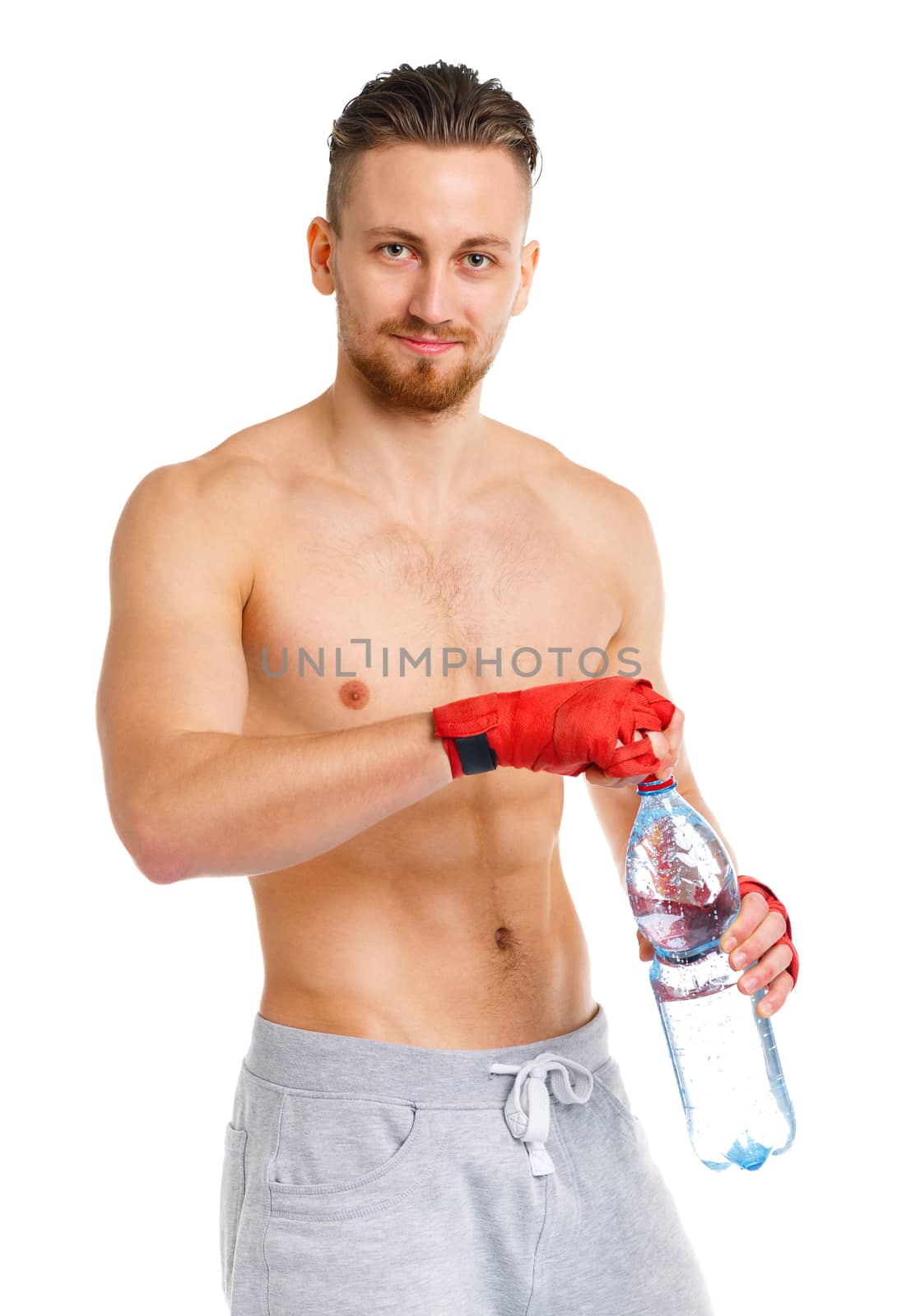 Sport attractive man wearing boxing bandages with bottle of wate by vlad_star