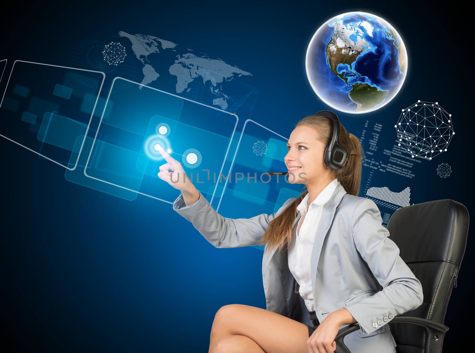 Businesswoman in headset sitting on chair, using touch screen interfaces. Globe above, with blue technology background. Element of this image furnished by NASA