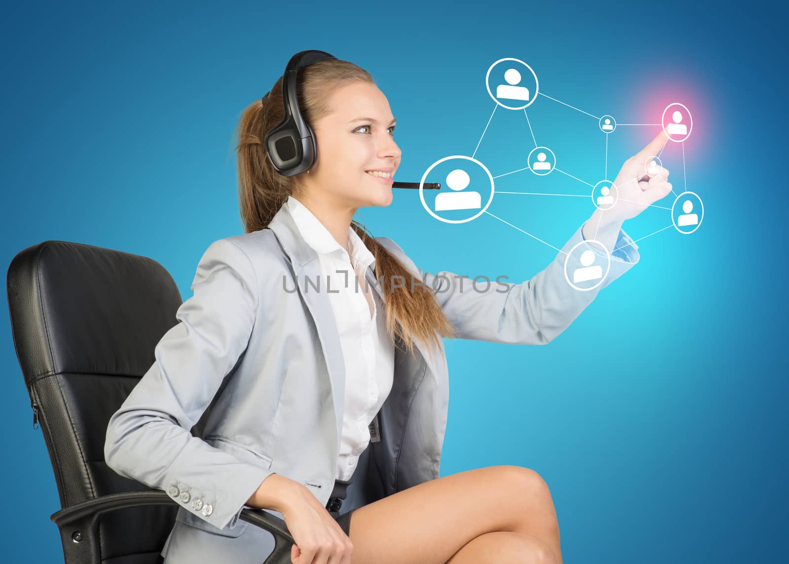 Businesswoman in headset sitting on chair using virtual interface. Blue gradient as backdrop
