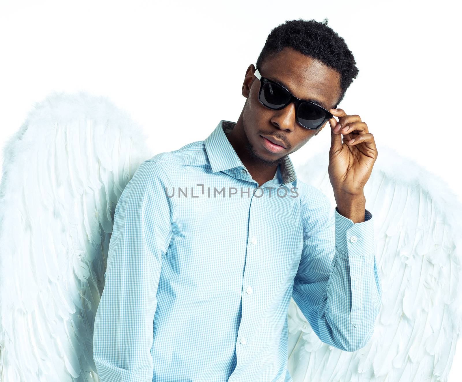 African American young man with angel wings in sunglasses