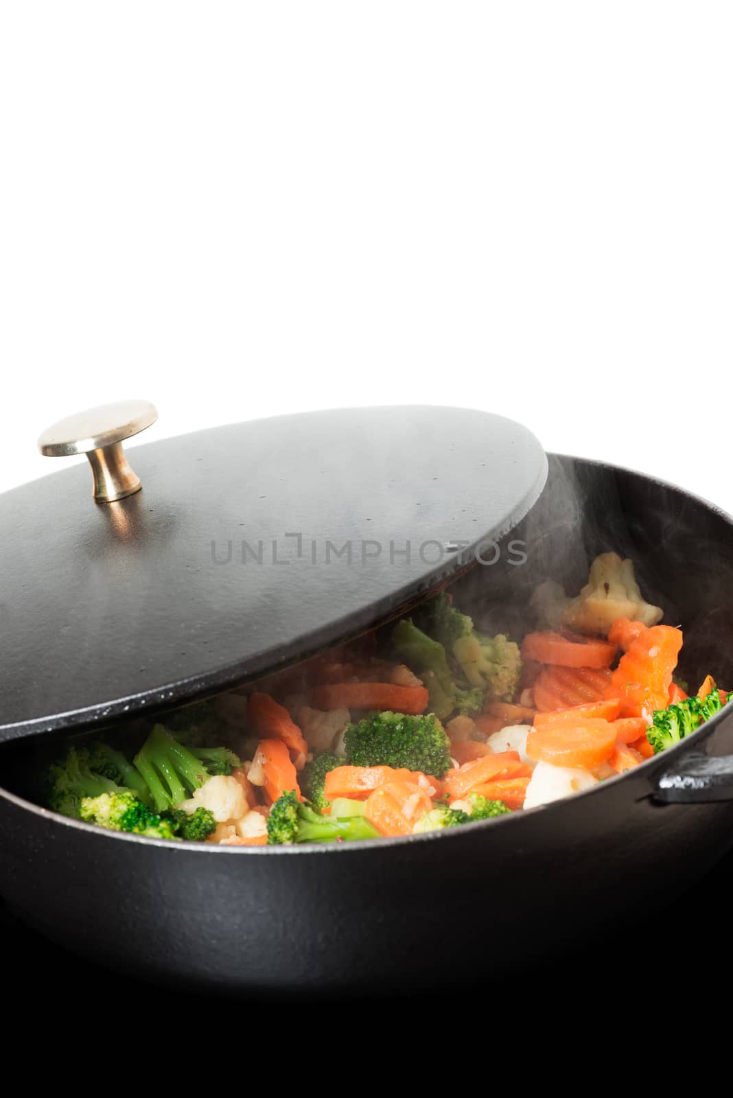Frying vegies in skillet vertical copy space by Nanisimova
