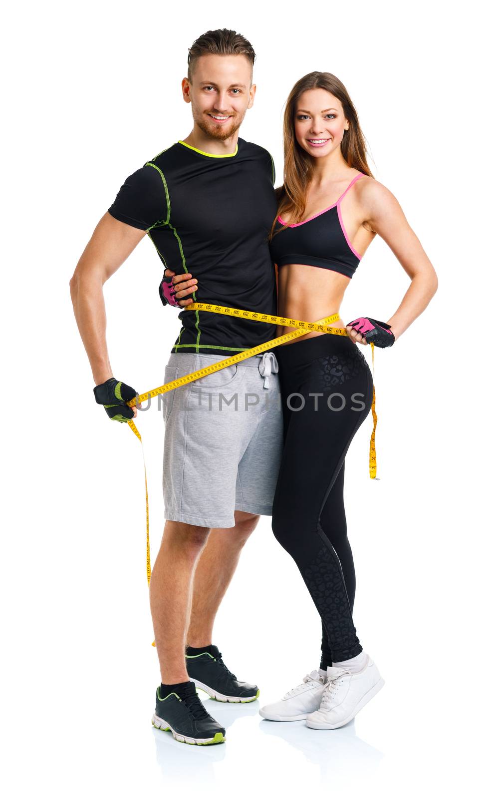 Happy sport couple - man and woman with measuring tape on the white background