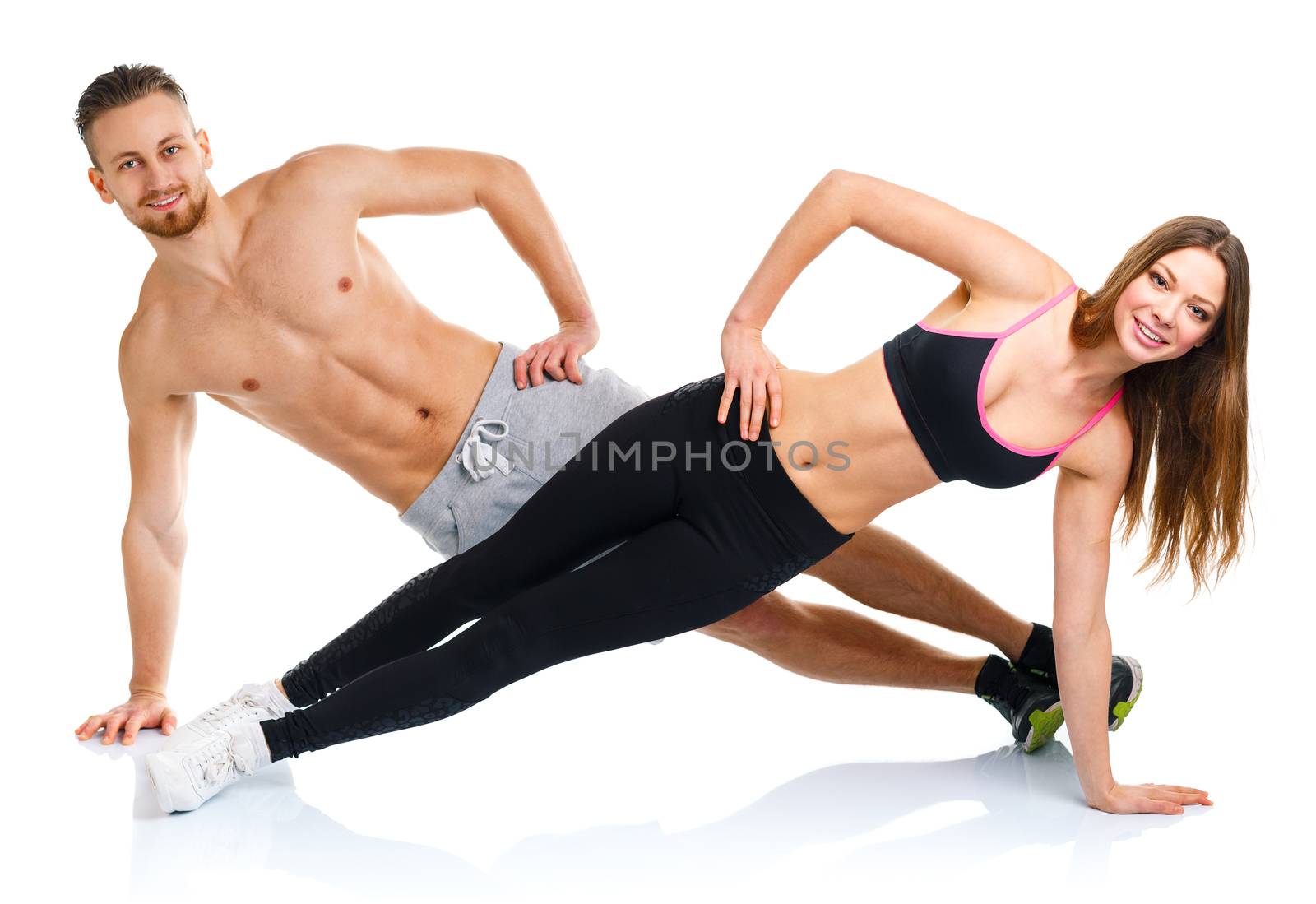Sport attractive couple - man and woman doing fitness exercises  by vlad_star