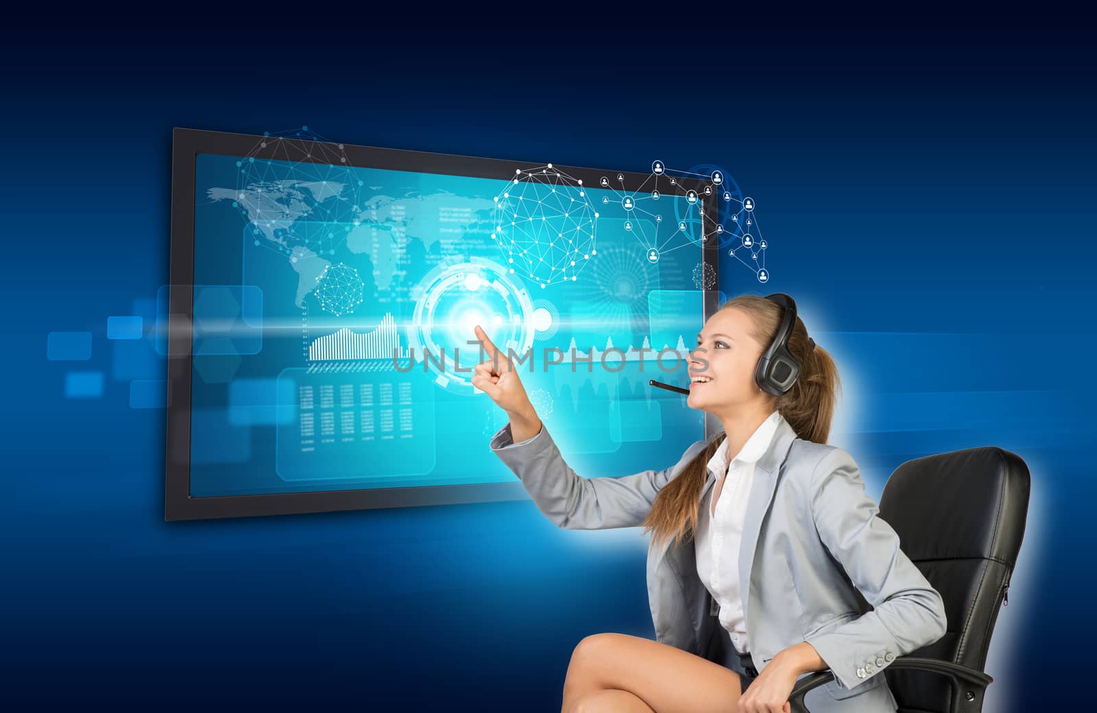 Businesswoman in headset using touch screen interface with world map, graphs and other elements, on blue background
