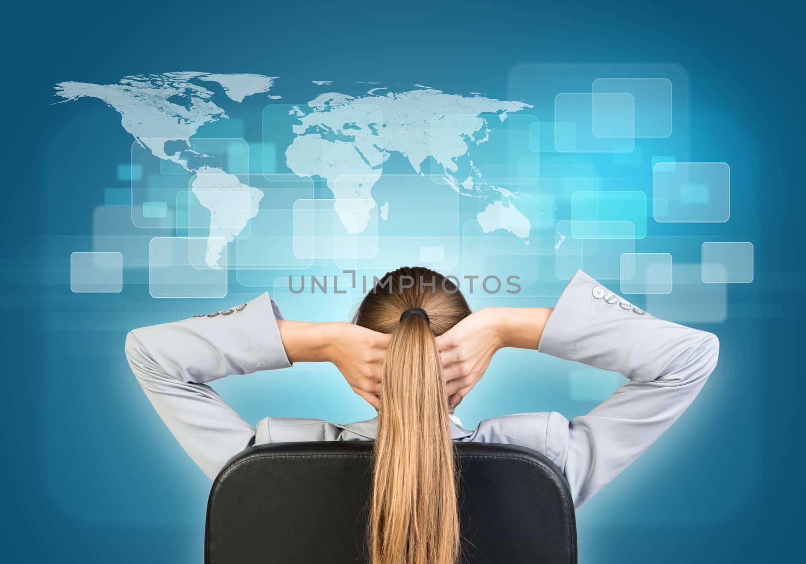 Businesswoman sitting on office chair with hands clasped behind her head, in front of world map and transparent rectangles