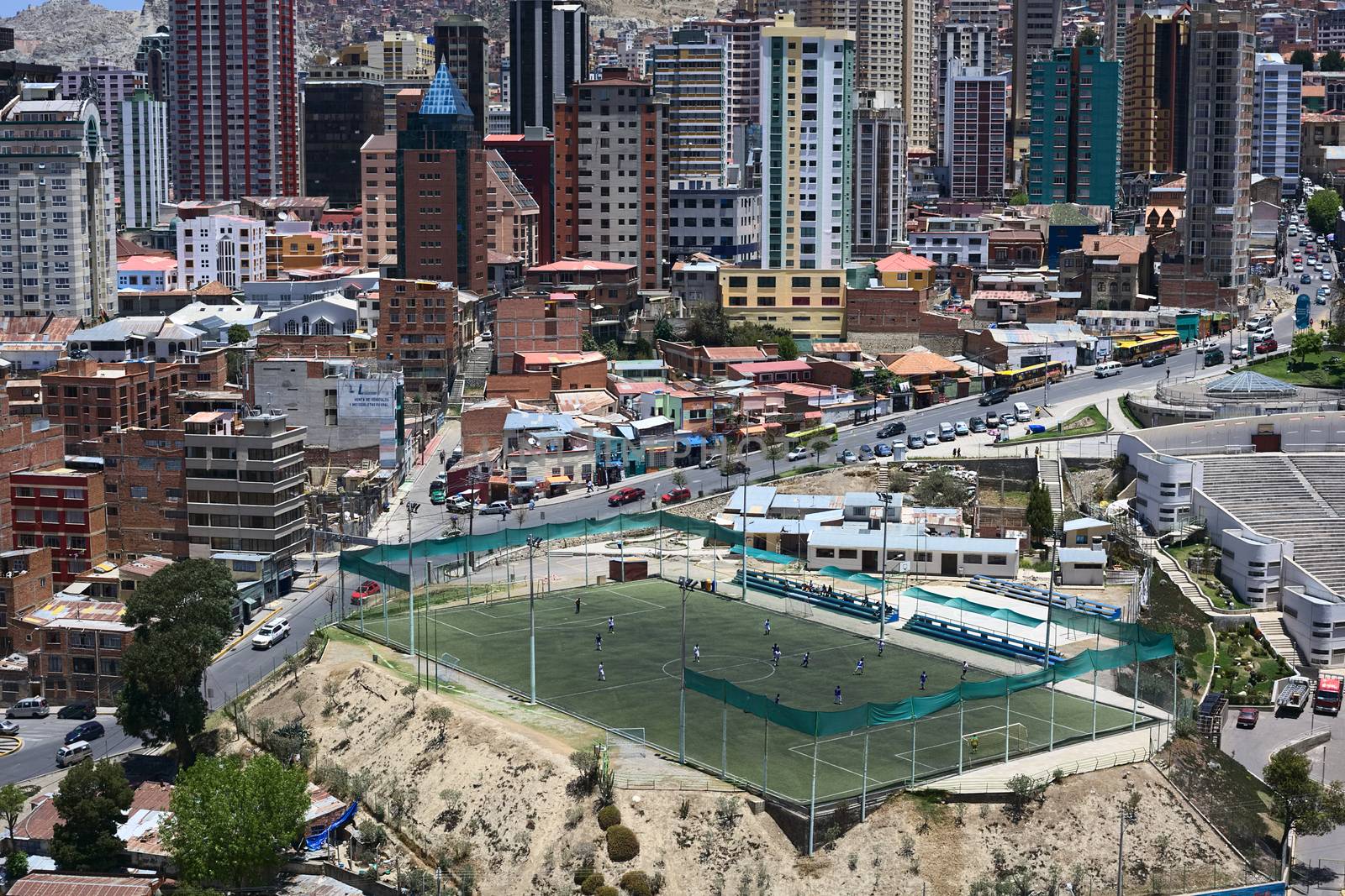 LA PAZ, BOLIVIA - OCTOBER 14, 2014: Unidentified people playing football on the pitch Cancha Zapata along Zapata avenue close to the Parque Urbano Central (Central Urban Park) on October 14, 2014 in La Paz, Bolivia