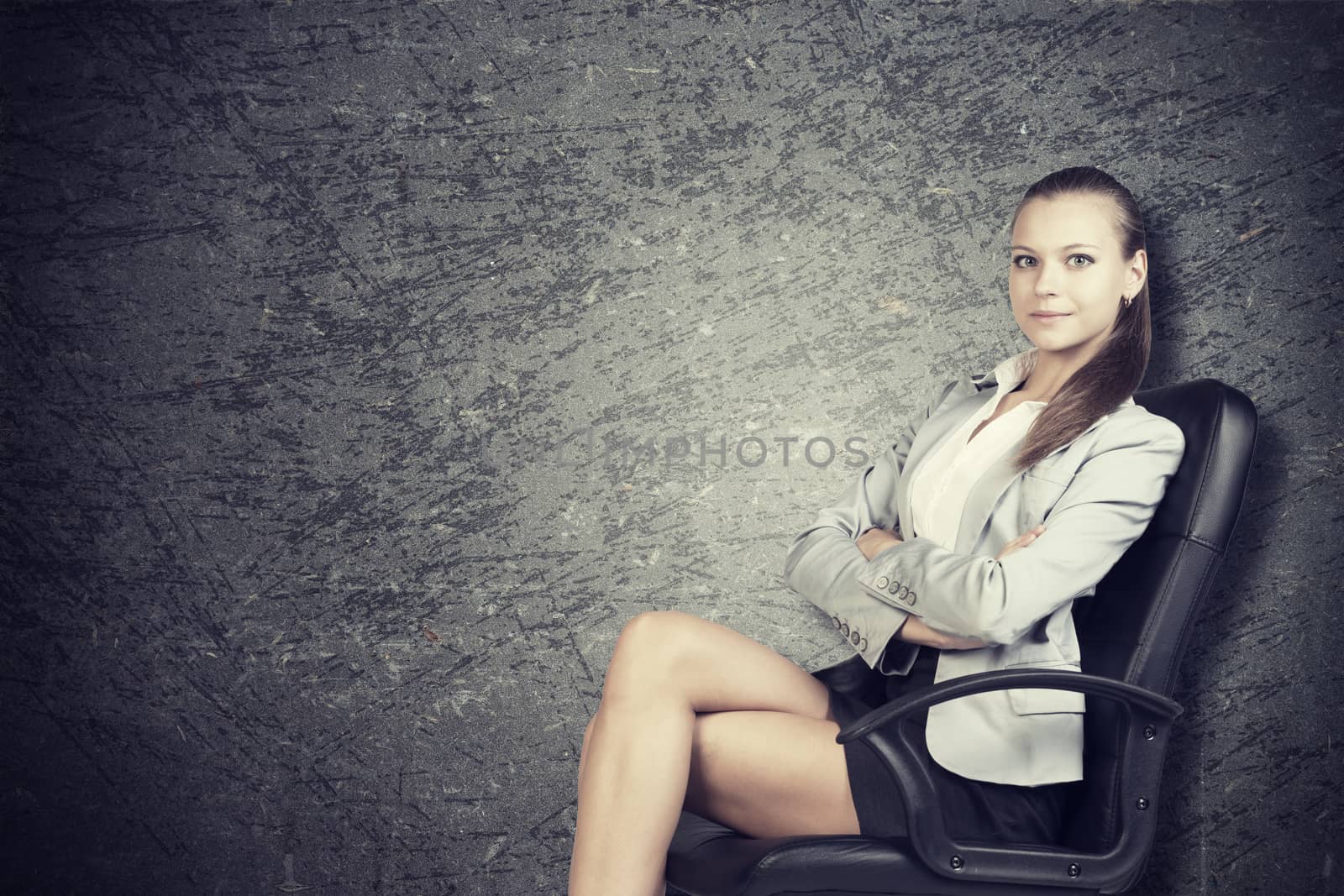 Businesswoman in office chair, looking at camera, over grunge scratchy background