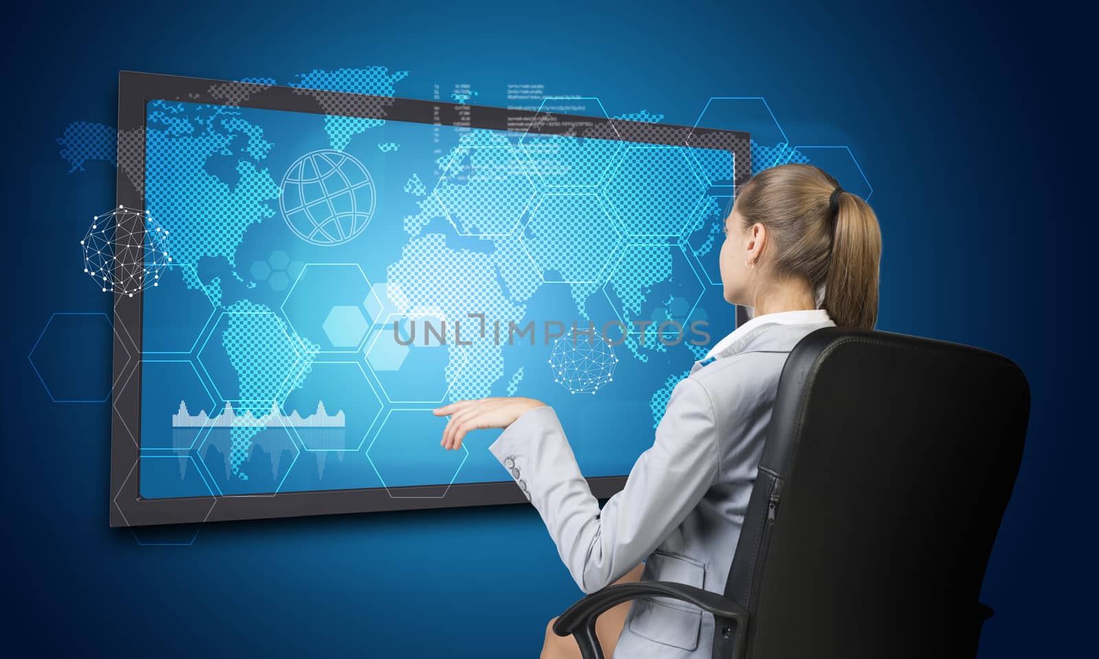 Businesswoman looking at touch screen interface by cherezoff