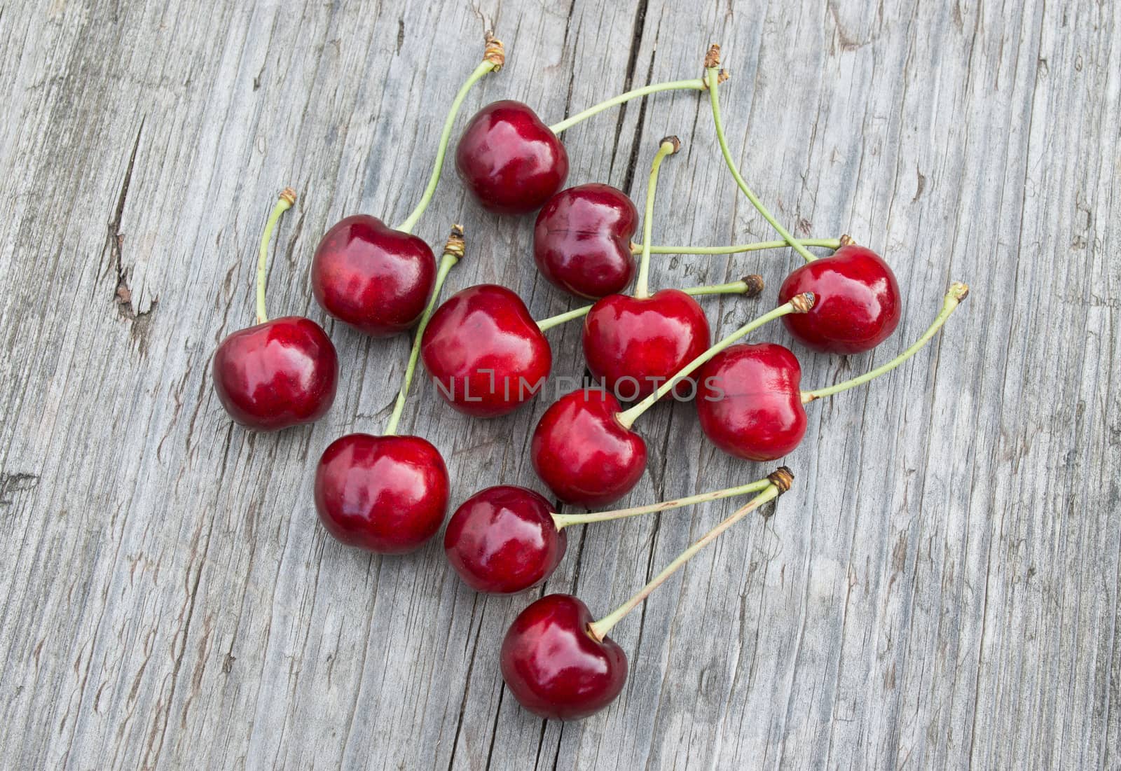 Sweet cherries on the old wooden table