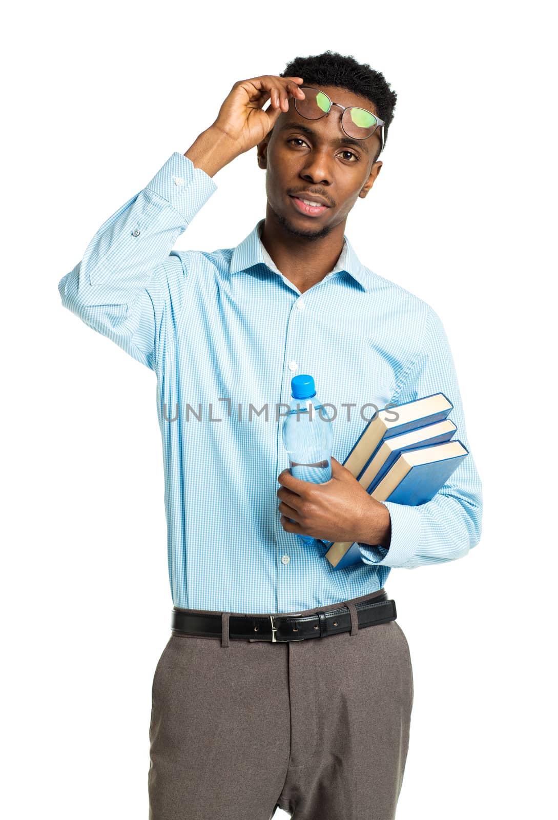 Happy african american college student standing with books in his hands on white background