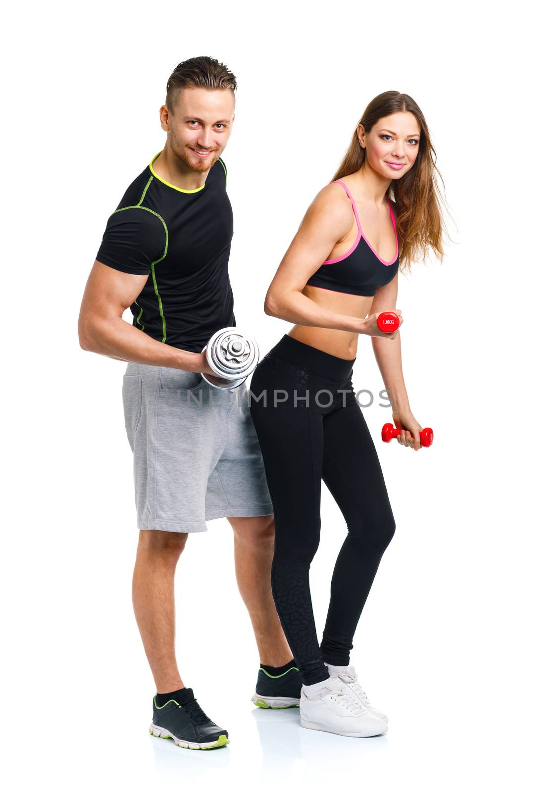 Sport couple - man and woman with dumbbells on the white background