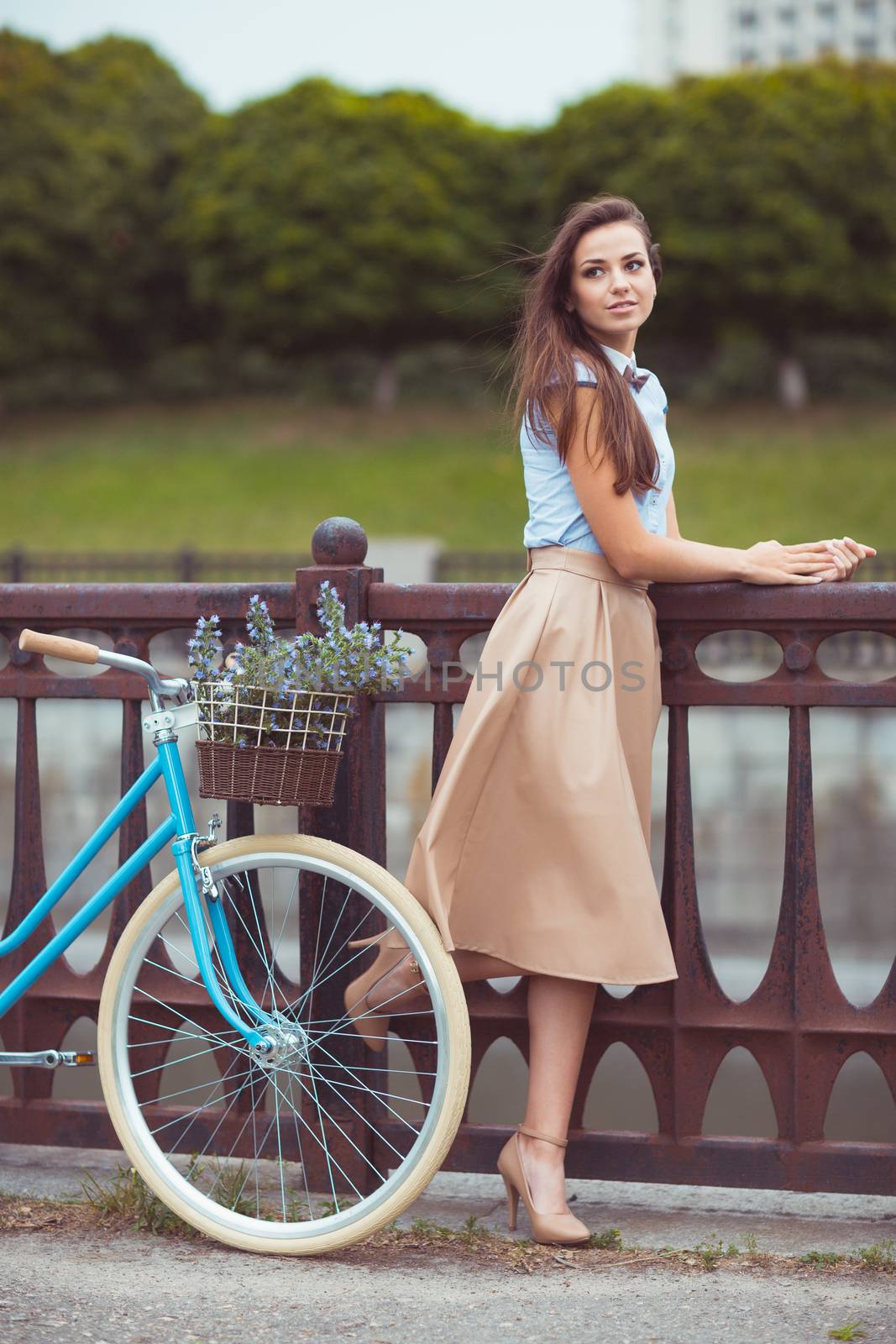 Young beautiful, elegantly dressed woman with bicycle by vlad_star