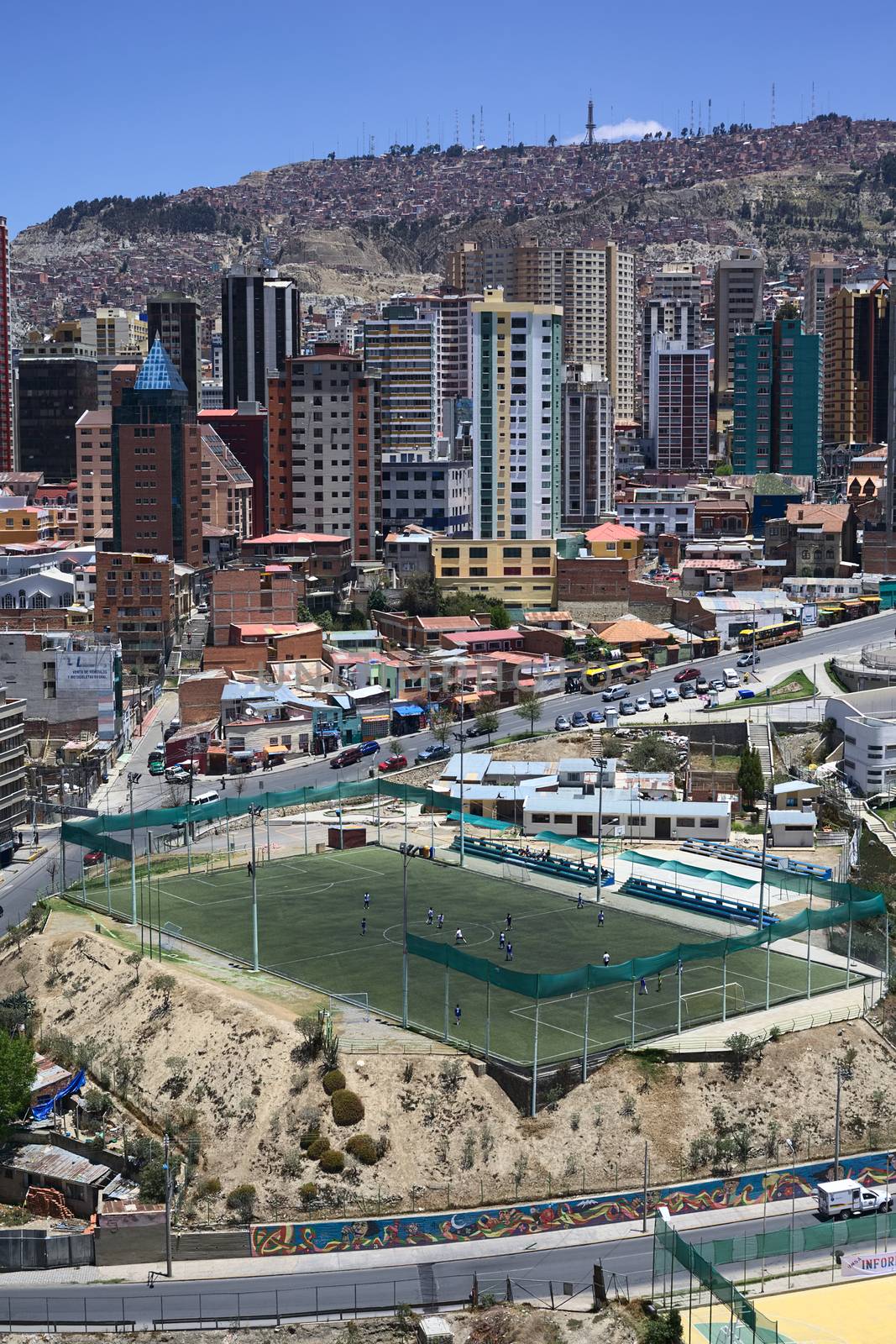 LA PAZ, BOLIVIA - OCTOBER 14, 2014: Unidentified people playing football on the pitch Cancha Zapata along Zapata avenue close to the Parque Urbano Central (Central Urban Park) on October 14, 2014 in La Paz, Bolivia