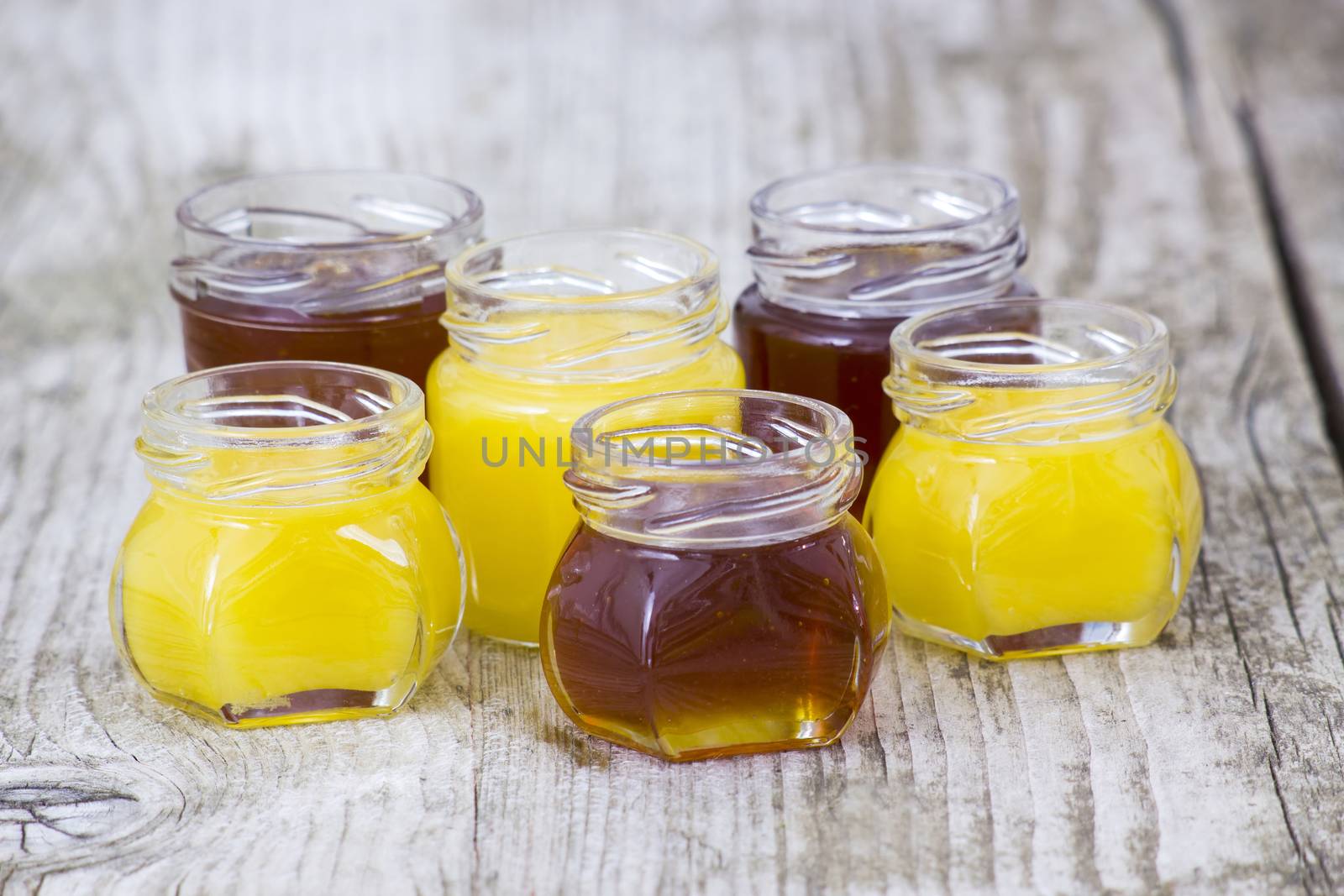 jars of honey on wooden background