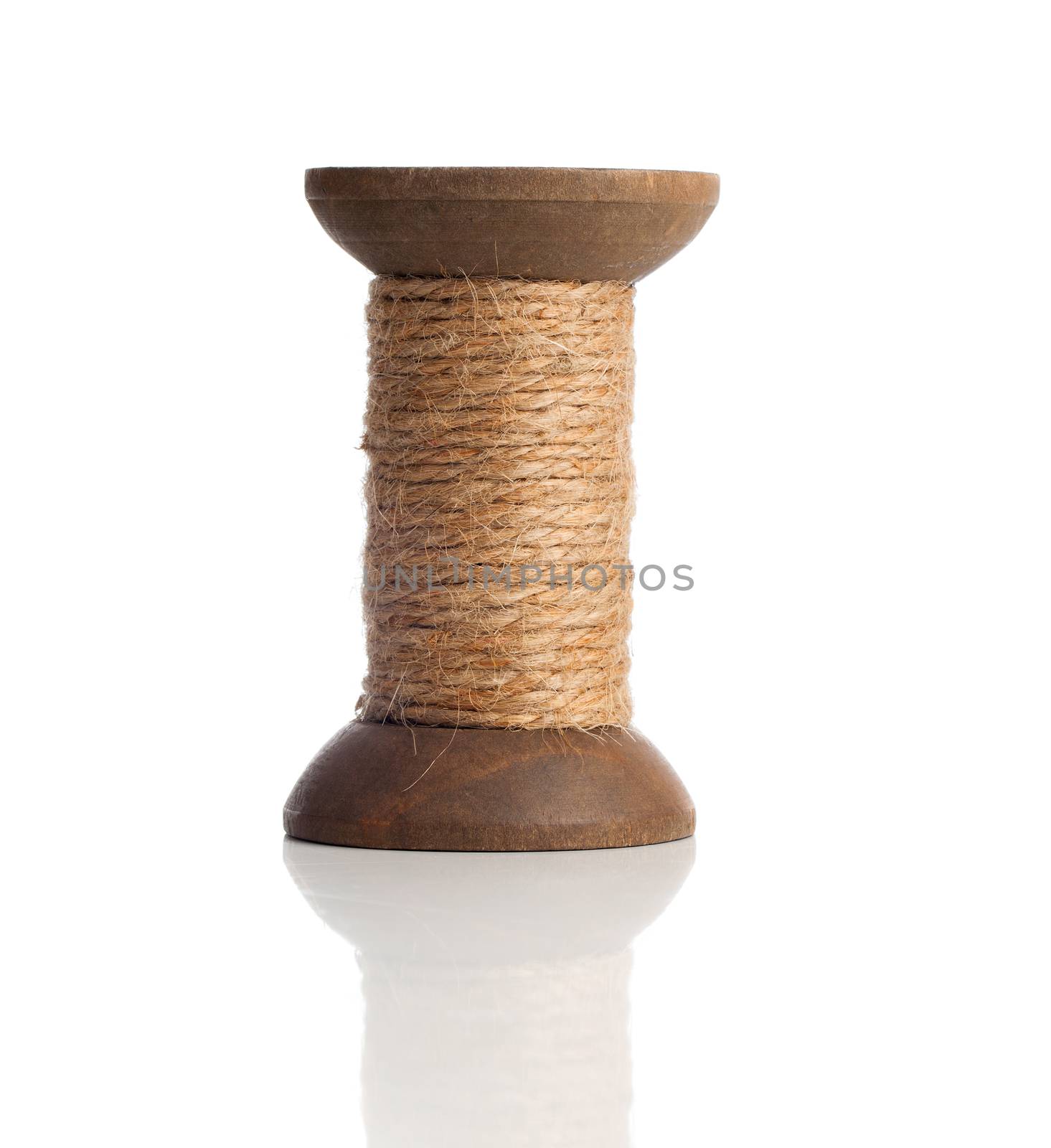 Old wooden bobbins of thread, vintage, isolated on white  by motorolka