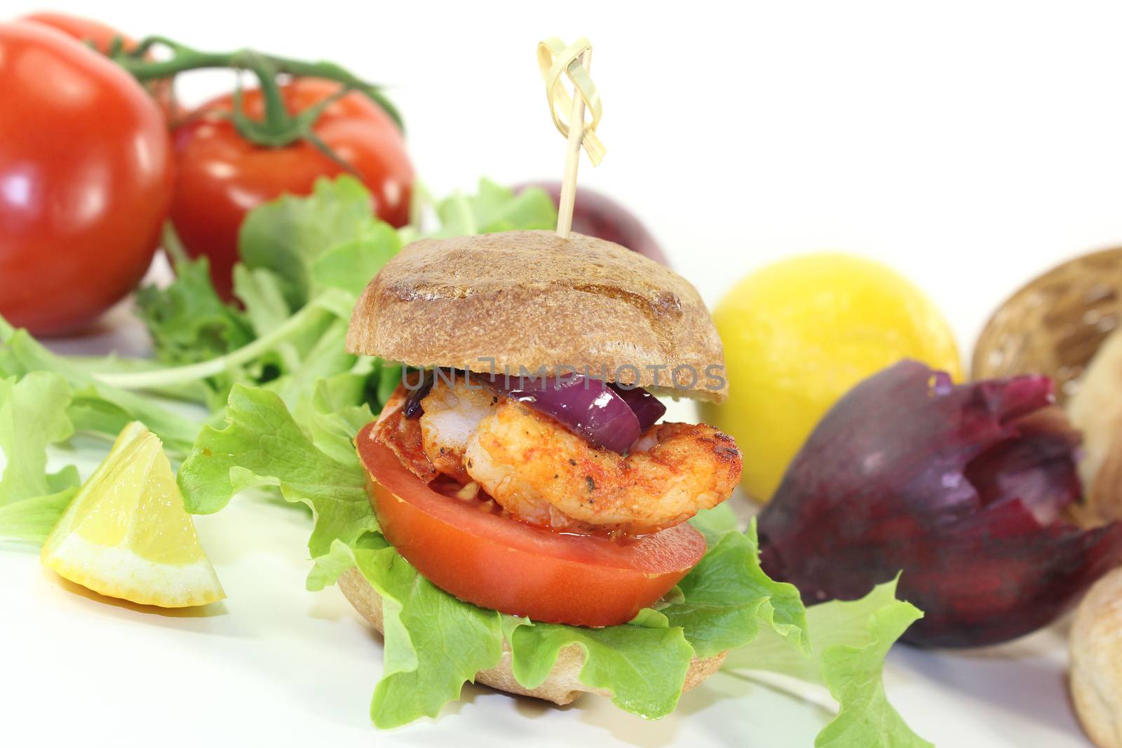 Shrimp burger with tomato, red onion and lettuce