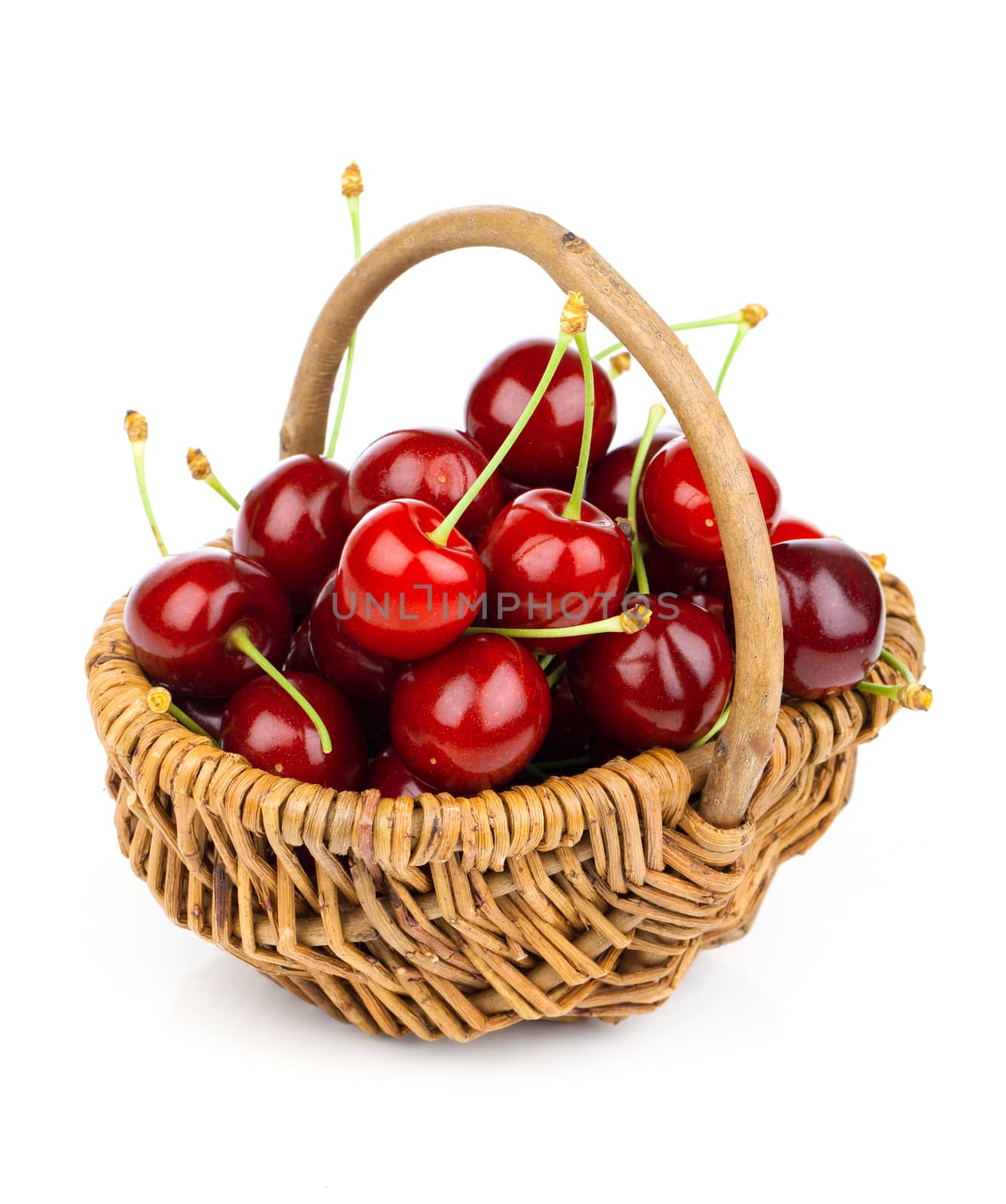 Basket full of fresh red cherry on a white background by motorolka