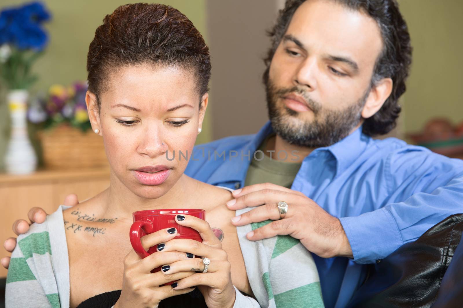 Sad woman with tattoo and concerned man with beard