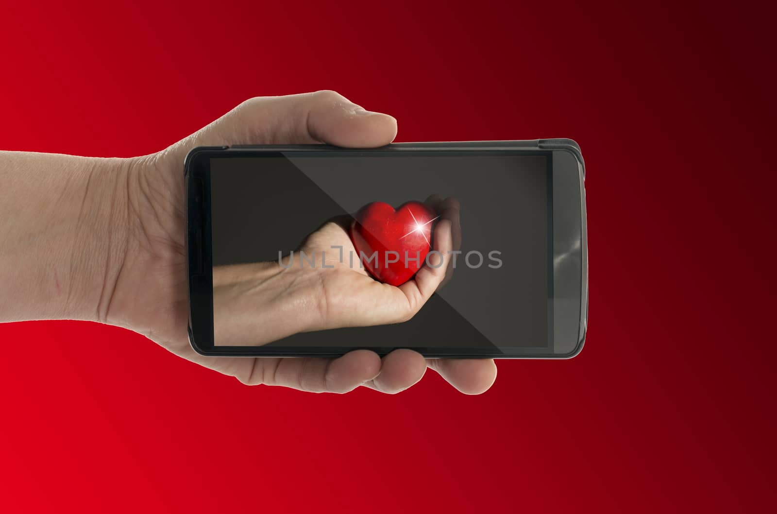 red heart on mobile phone  by compuinfoto