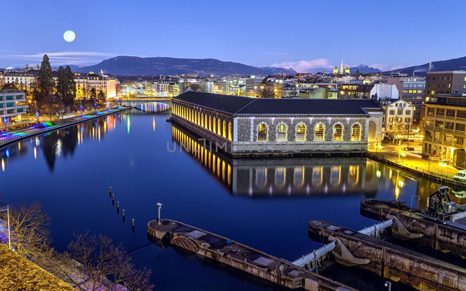 BFM, cathedral Saint-Pierre green tower and Rhone river by night with full moon, Geneva, Switzerland, HDR