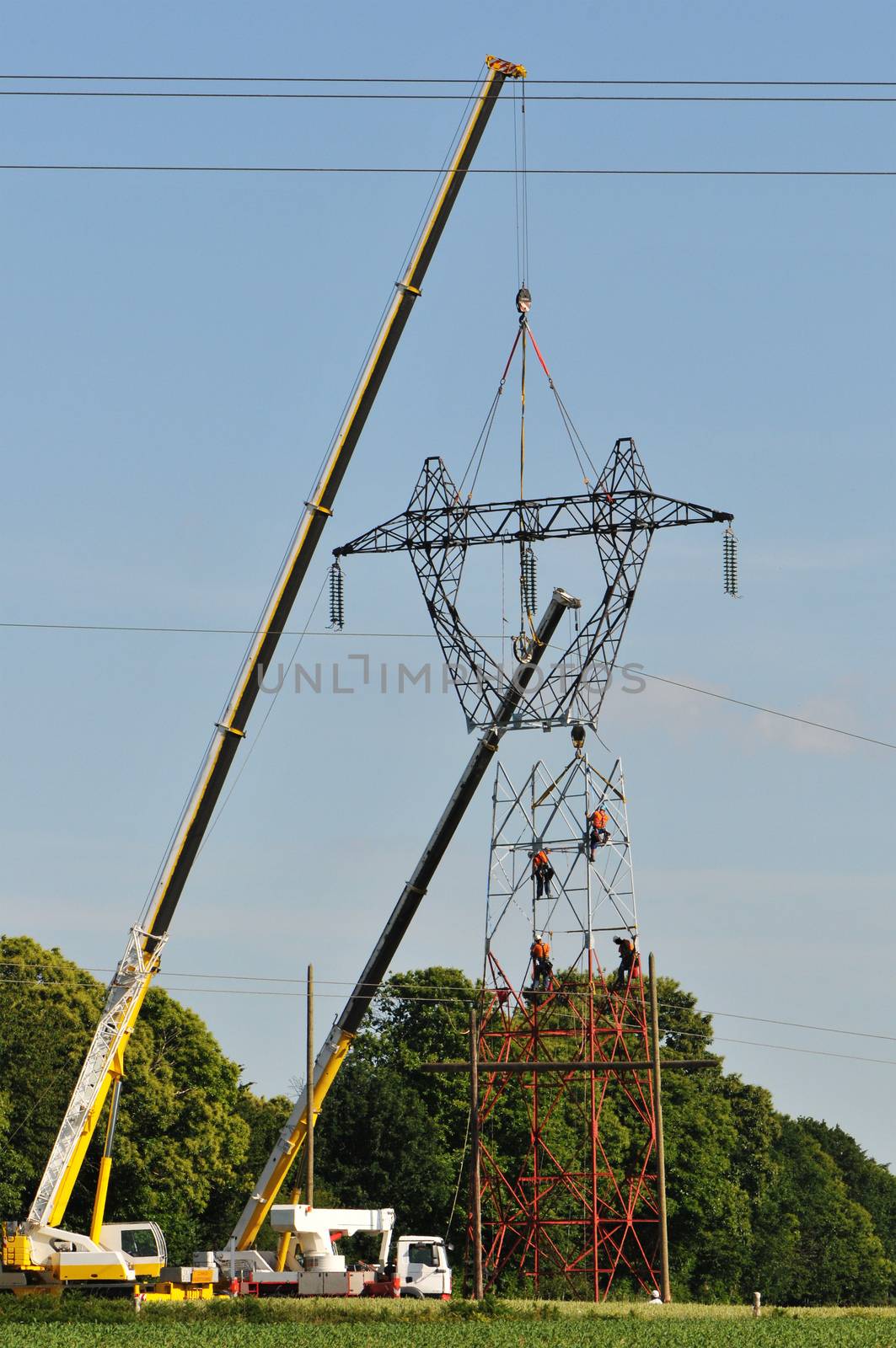 Electrical Top Changing with Two Cranes and a Blue Sky
