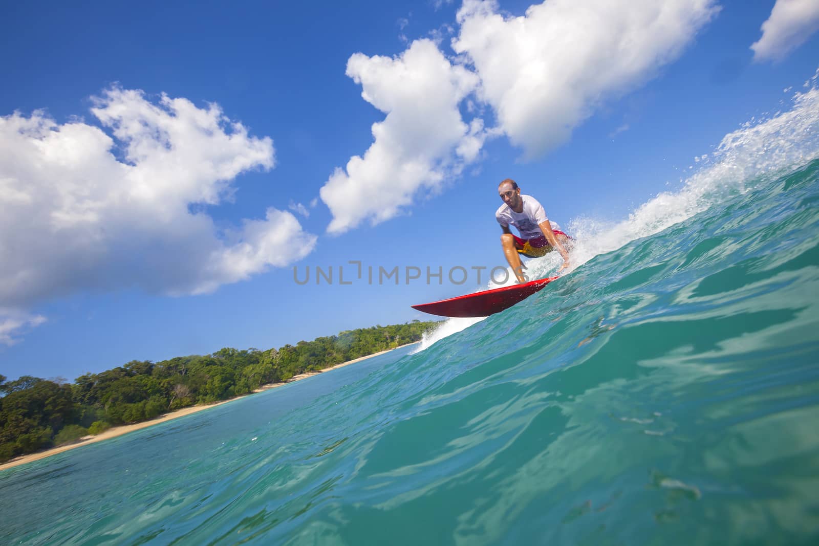 Surfer on Amazing Blue Wave, Bali island.