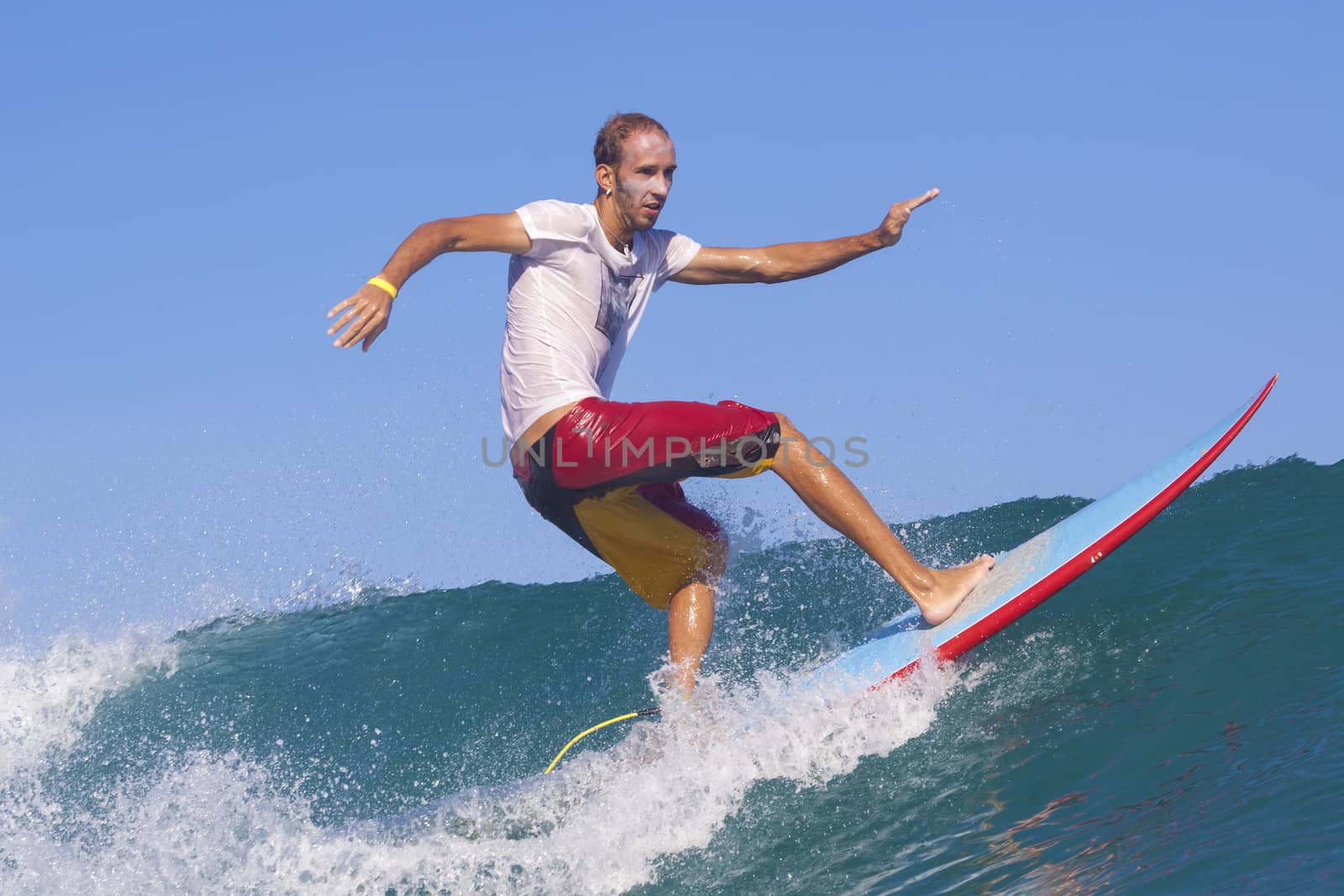 Surfer on Amazing Blue Wave, Bali island.